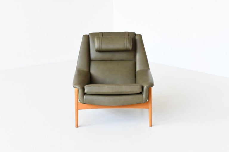 Beautiful shaped high back lounge chair designed by Folke Ohlsson for Dux, Sweden 1960. This well-crafted reclining chair is made to reach an ultimate level of the Scandinavian modern design. It is great looking from all sides and is also very