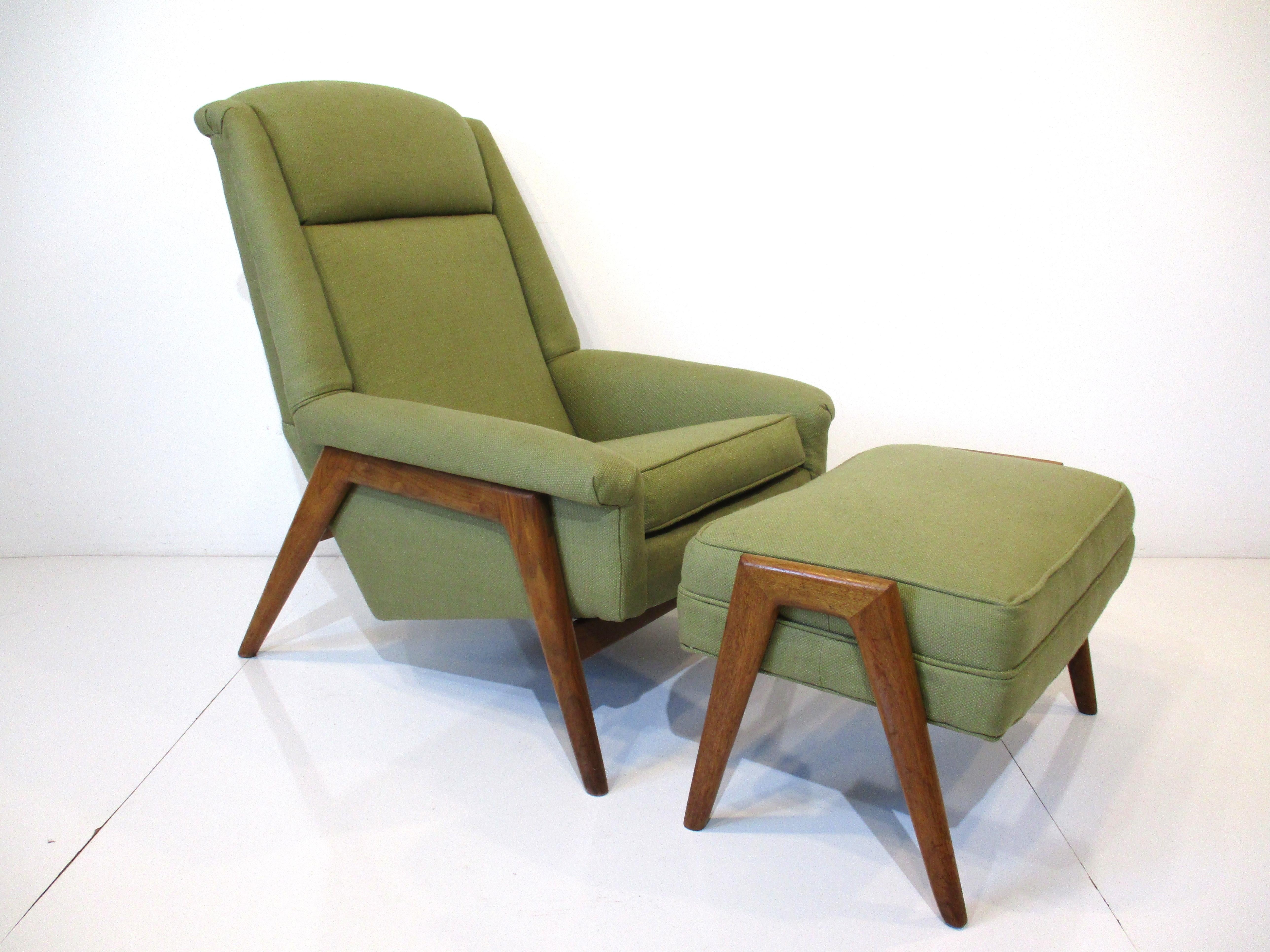 A very comfortable and well designed ergonomic styled upholstered lounge chair on a walnut frame with matching ottoman. Finished in a tight woven celery green contract fabric typical of the material used during the period, designed by Folke Ohlsson