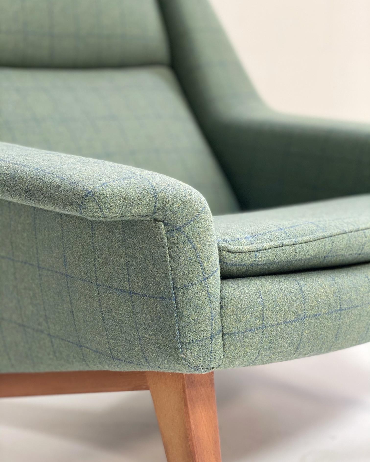 This big Folke Ohlsson lounge chair so cool and comfortable. The green and blue plaid upholstery is new and in beautiful condition. Throw a sheepskin over it for an even cushier seat.