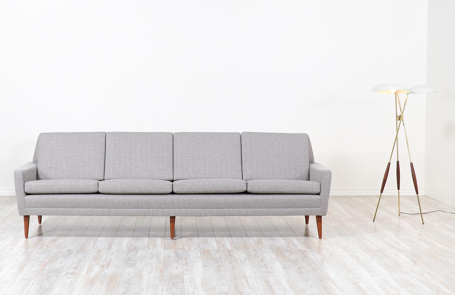 Elegant modern four-seat sofa designed by Folke Ohlsson for DUX in Sweden, circa 1950s. This stylish model 66-S4 sofa features a sturdy teak wood construction with new high-density foam, webbing straps, and tweed upholstery on the cushions for the