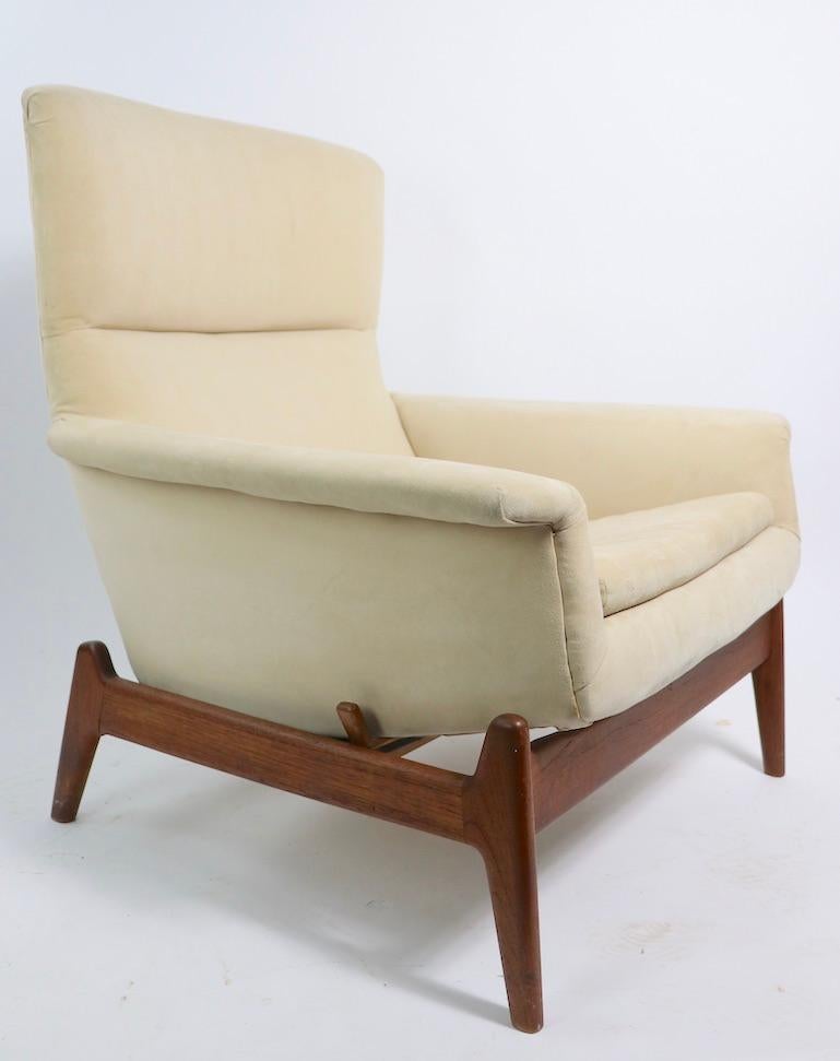 Wonderful Danish modern style recliner, designed by Folke Ohlsson for DUX of Sweden, circa 1960s. The chair will rock on the platform, or can be locked into position. Structurally sound and sturdy, fully functional and marked, upholstery shows some