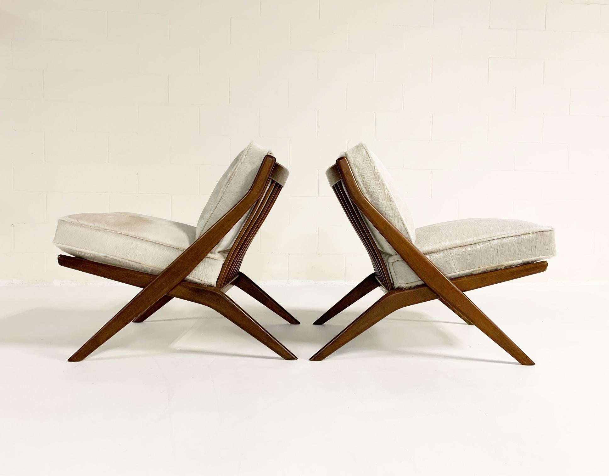 A pair of very cool lounge chairs designed by Folke Ohlsson for DUX of Sweden, circa 1950s. Featuring a solid walnut wood frame, providing exceptional comfort. Both cushions are brand new, 100% feather-filled, crafted from our luxurious ivory
