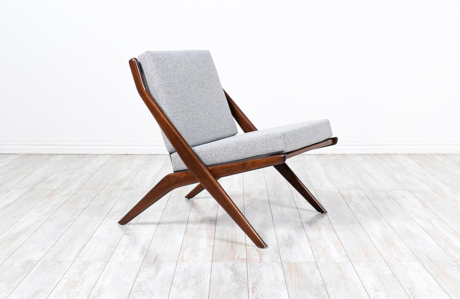 Elegant modern lounge chair designed in Sweden by Folke Ohlsson for Dux of Sweden circa 1950s. This minimalist lounge chair features a solid walnut wood frame with new high-density foam cushions and gray-colored tweed fabric upholstery. This