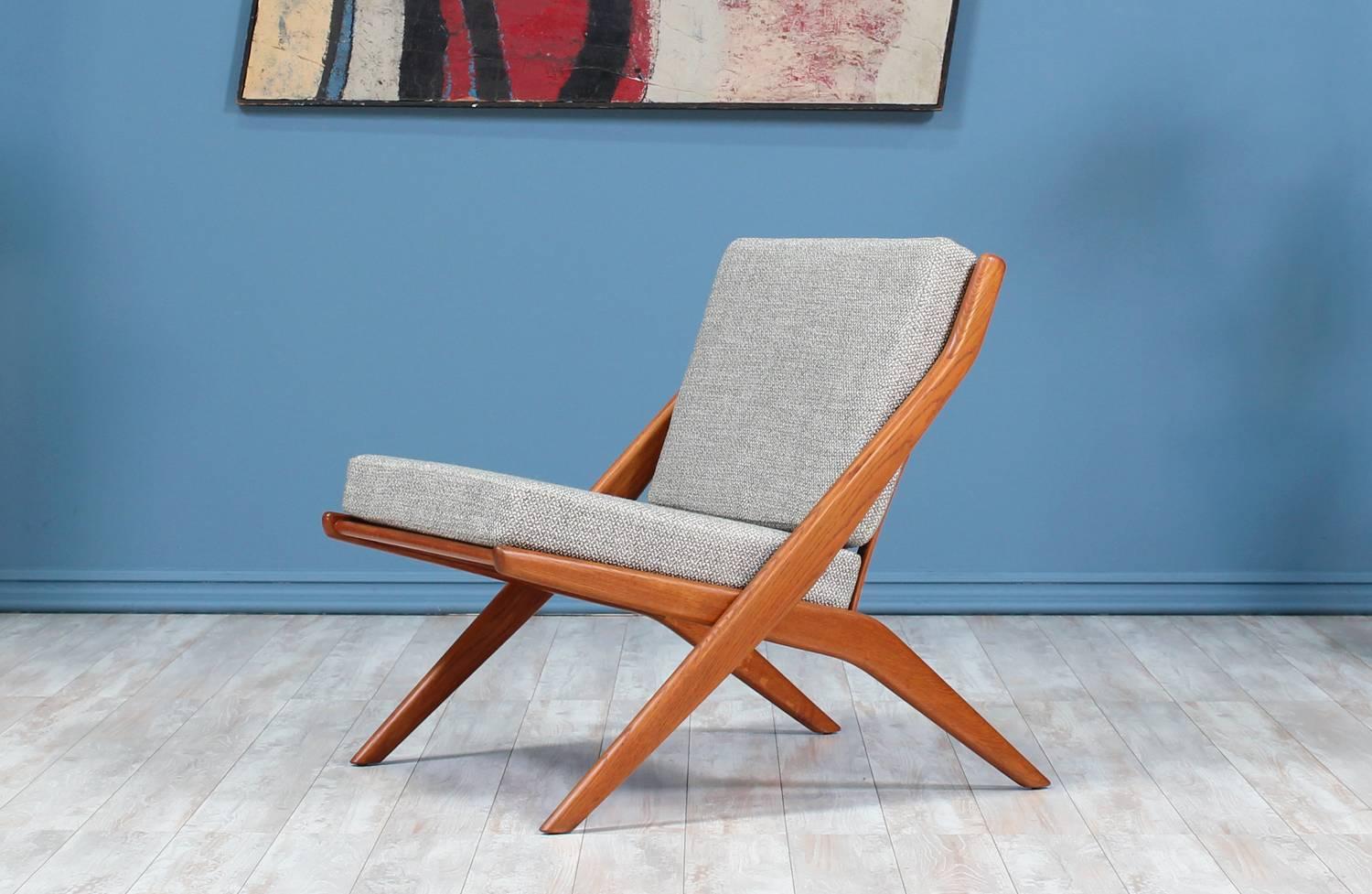 Lounge Chair designed by Folke Ohlsson for Dux of Sweden circa 1950’s. Newly refinished and new upholstered foam cushions with a high-quality tweed fabric in a textured grey color. This Scandinavian modern design features a scissor-like teak wood