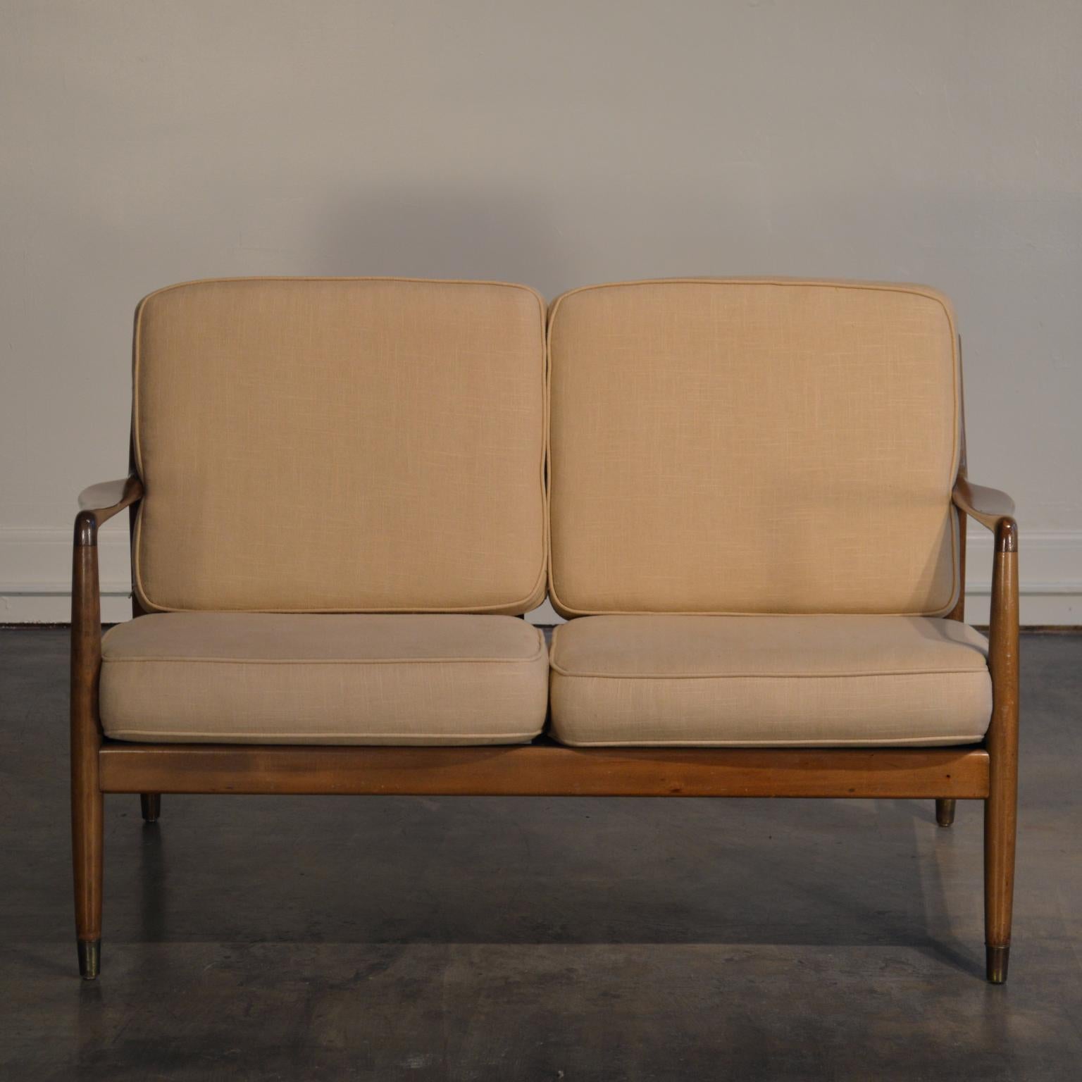 Designed for DUX by Folke Ohlsson and produced in the 1960s. This is a charming and lightweight Scandinavian Modern loveseat/settee made from stained and beech wood.

Retains DUX paper label. The settee has new straps for the seat base, new