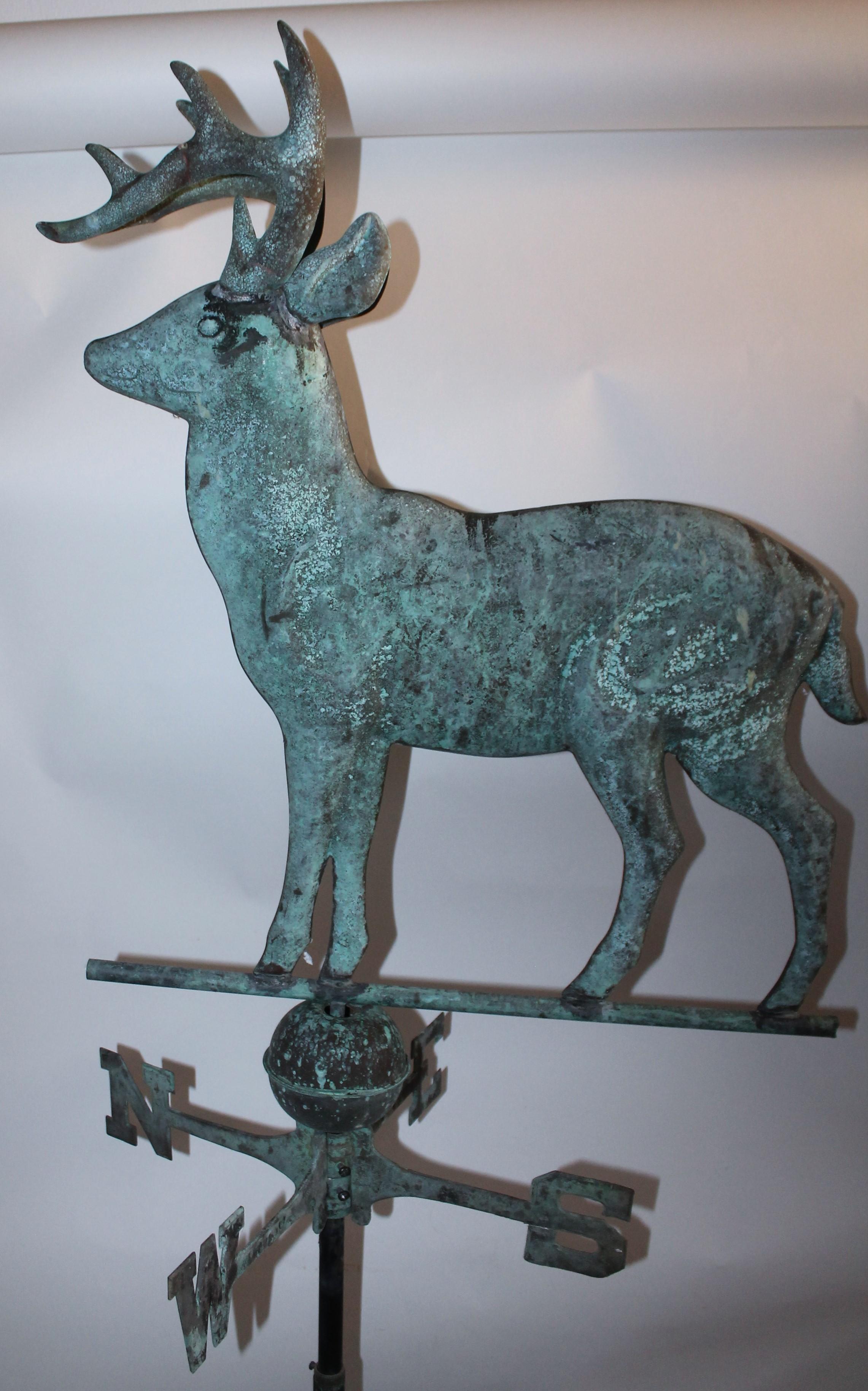 This folky 20th century deer copper full body weather vane is in good as found condition. Found in the mid west. It is mounted on a tall iron stand with the original directionals. Fantastic for a cabin or lodge.