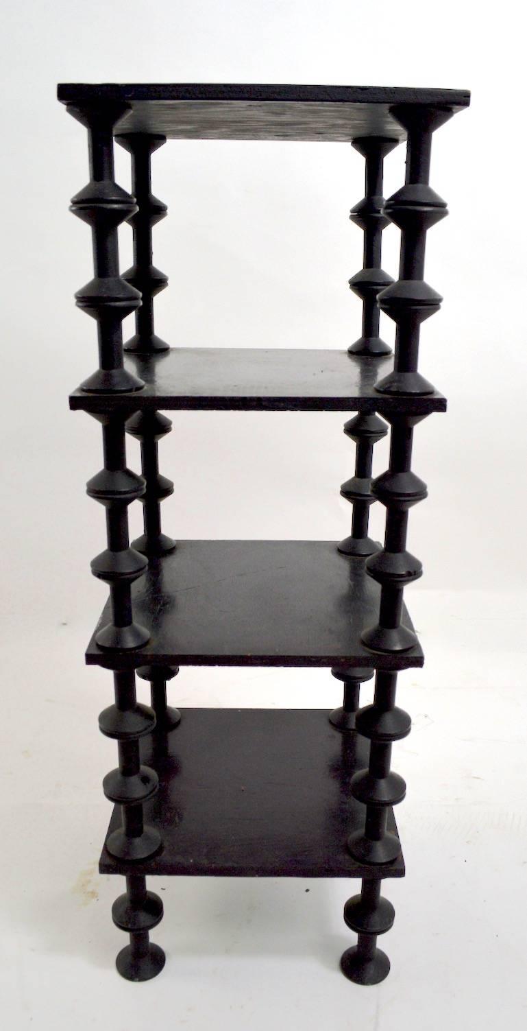 Striking black spool stand, folky and architectural four-tier table.
 