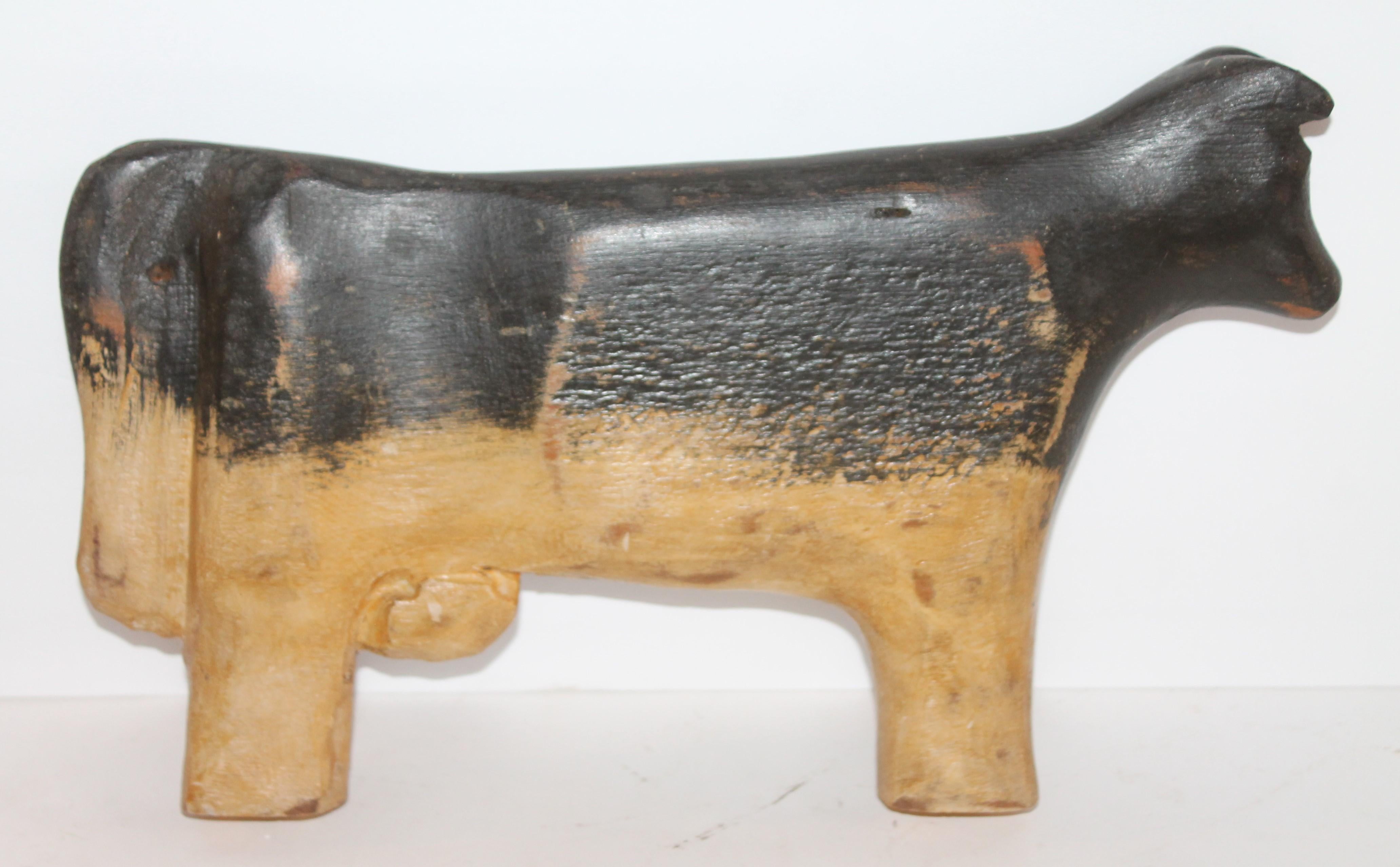 This hand carved Folk Art cow is signed J.D. Meadows 1941. This hand carved and painted folky cow stands alone and has a fantastic personality.