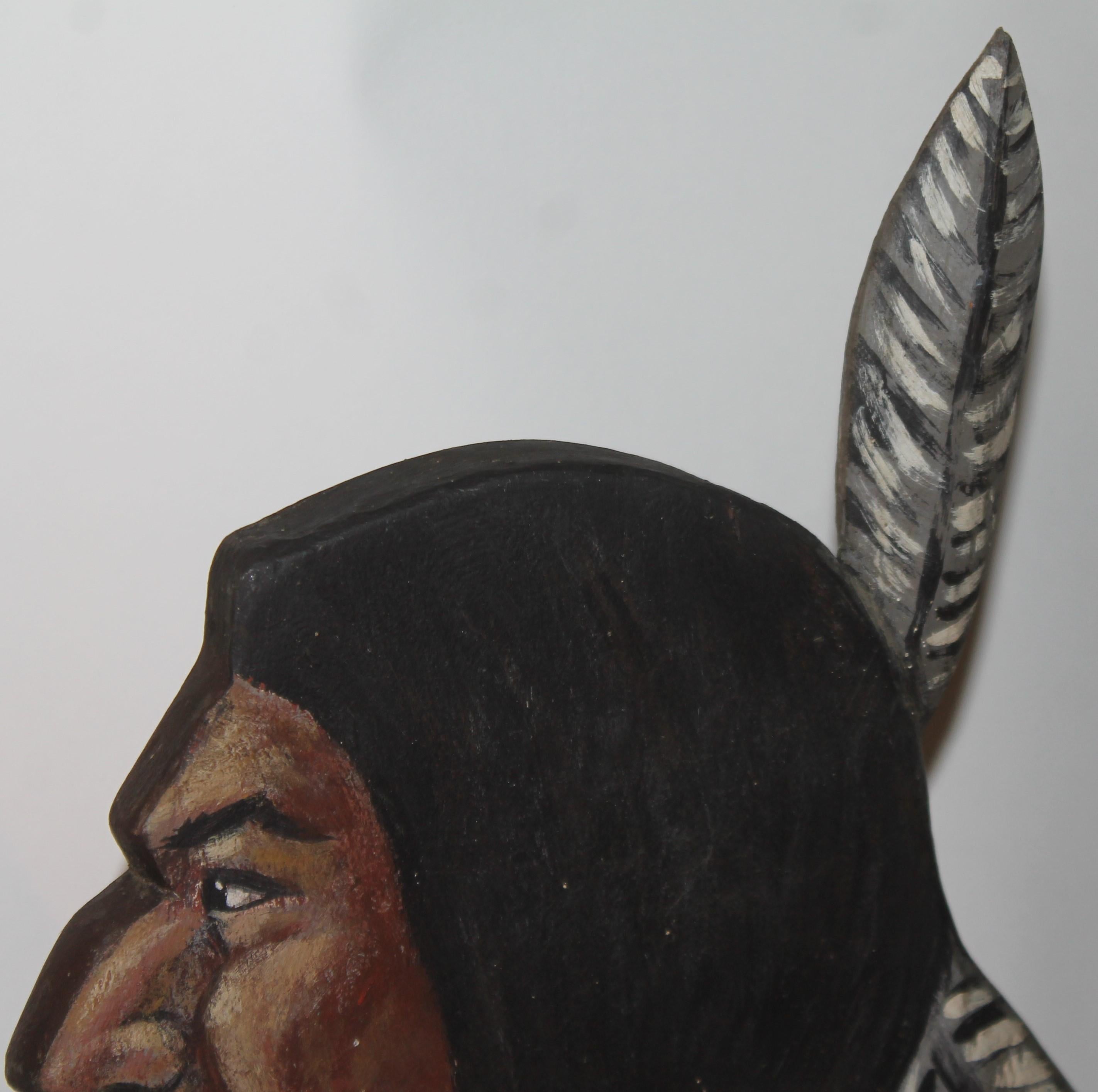 This amazing hand carved and painted Indian head with a feather in his head is in fine condition and has a great patina.