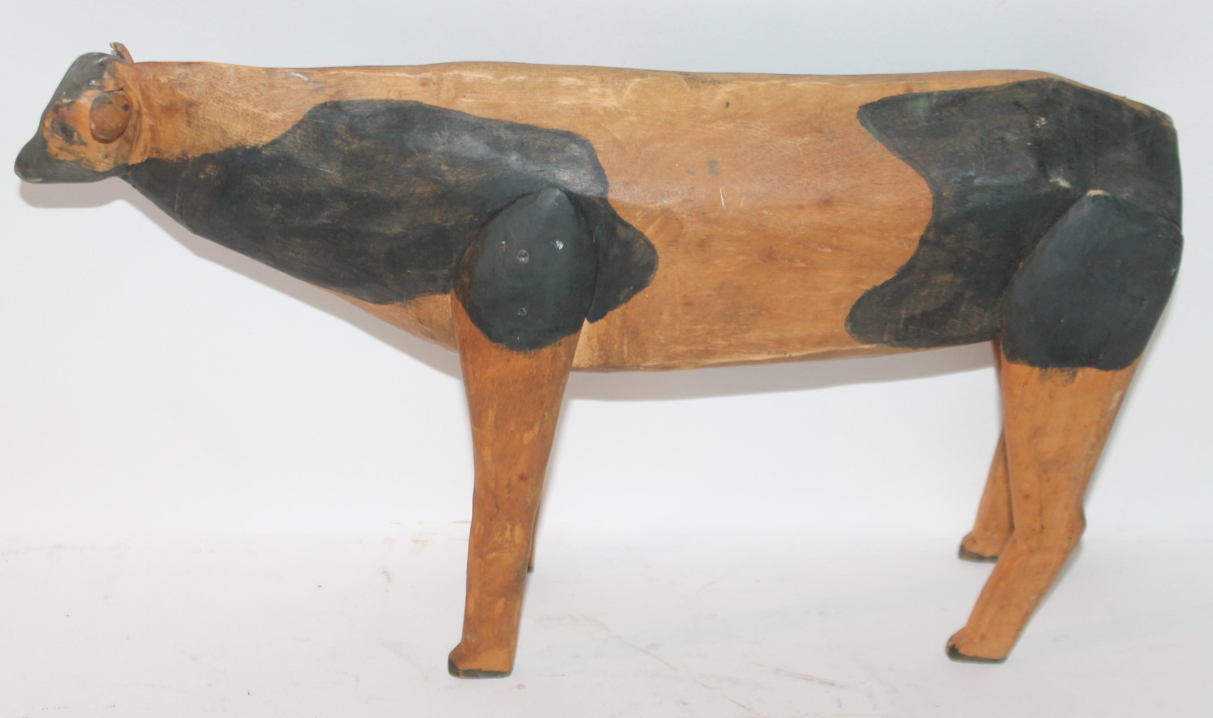 This funky all original paint and hand carved folky cow is in good condition with wear consistent from age and use.
