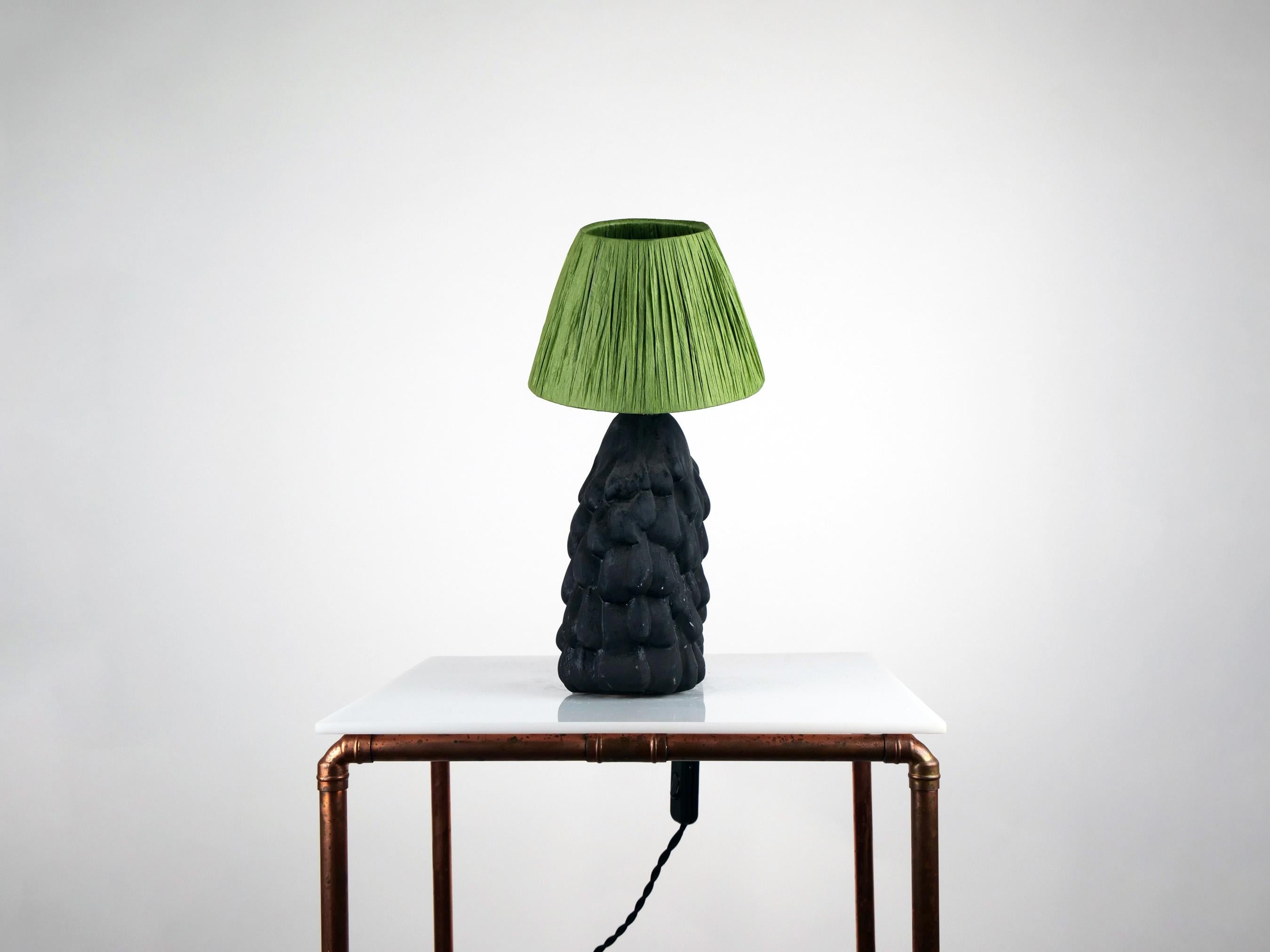 Matte black base with green raffia shade.

Estimated processing time is 4 weeks from order confirmation.

Pictured with a Mini Globe LED E27 Bulb. Bulb not included.

To pair this base with a shade in an alternative colour or material, click the