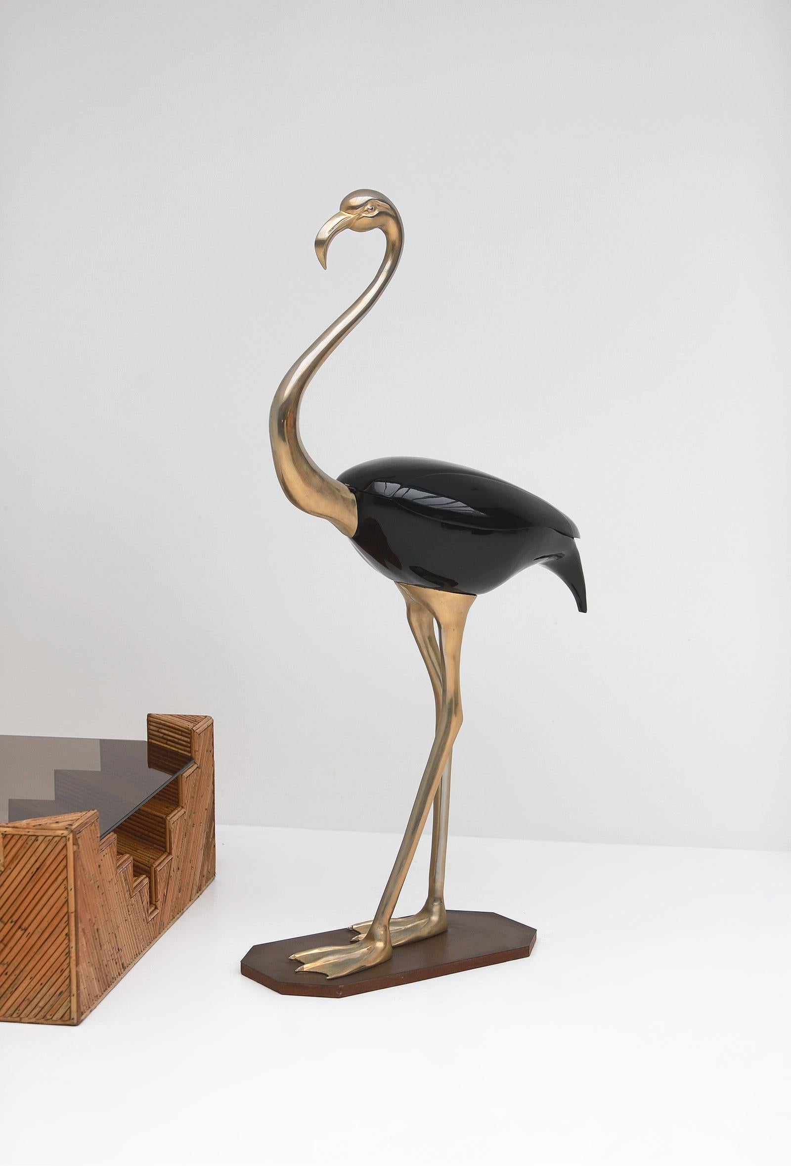 Large flamingo sculpture by Fondica, France 1970. The sculpture is fully made of brass and has a black lacquered storage compartment. When opening the lid, an original metal support helps the compartment under the wings to stay open. Inside the