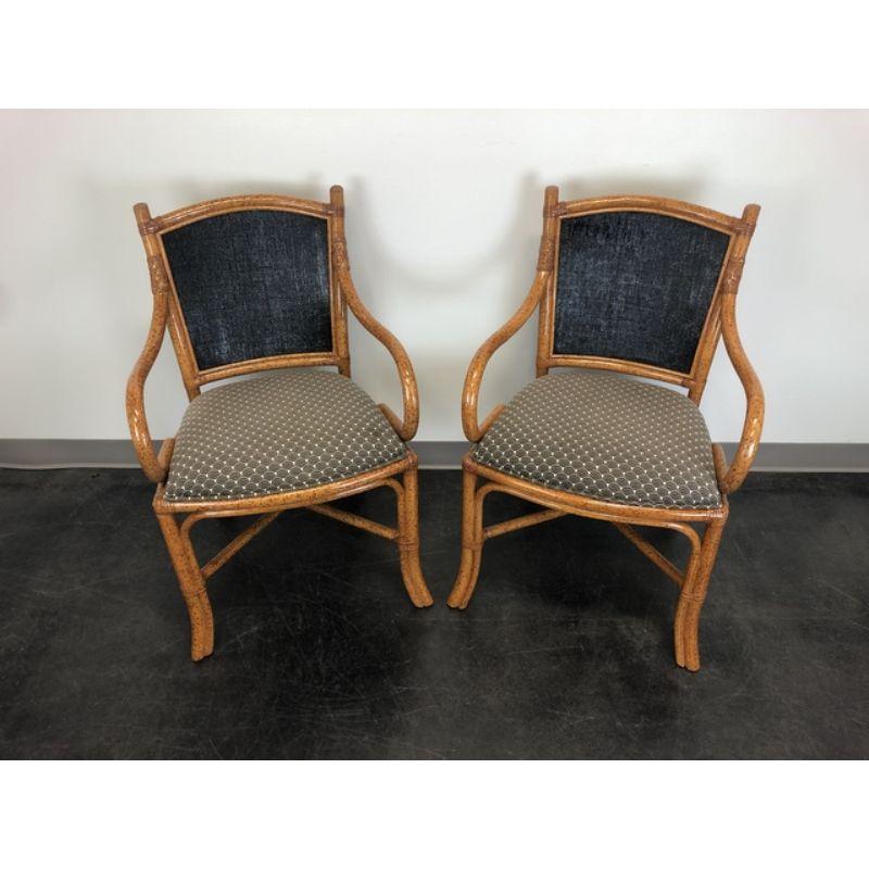 A pair of Tropical style dining armchairs by Fong Brothers, of Los Angeles, California, USA. Faux bamboo with fabric upholstered backs and seats. Made in the late 20th Century.

Measures: Overall: 23w 22.5d 34h, Seats: 18w 17d 20h, Arms: