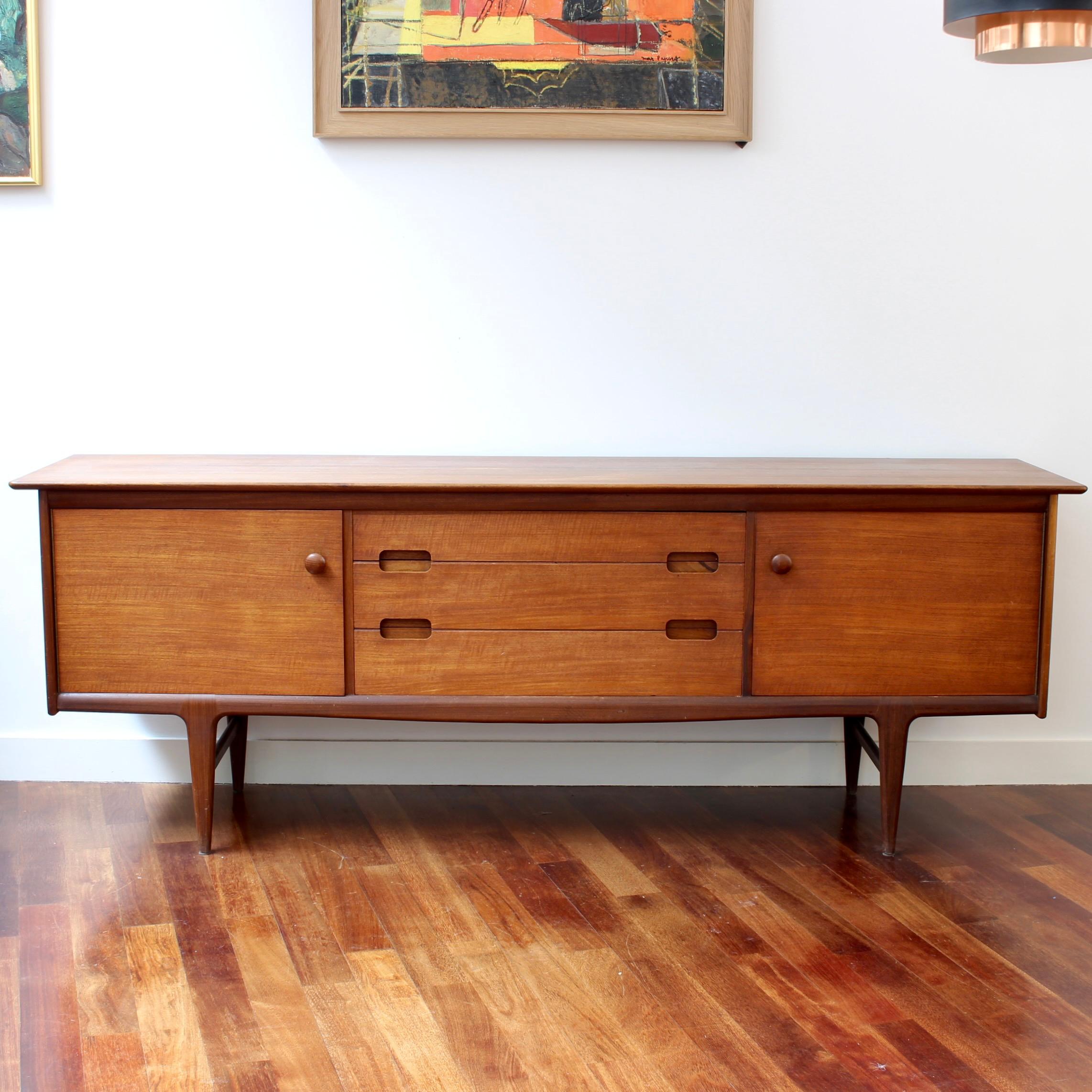 ‘Fonseca’ sideboard in teak and afrormosia wood (resembles teak) designed by John Herbert for A. Younger Ltd. (circa 1950s). This model was produced in relatively low numbers therefore rarely comes to market. There are two cupboard spaces that sit