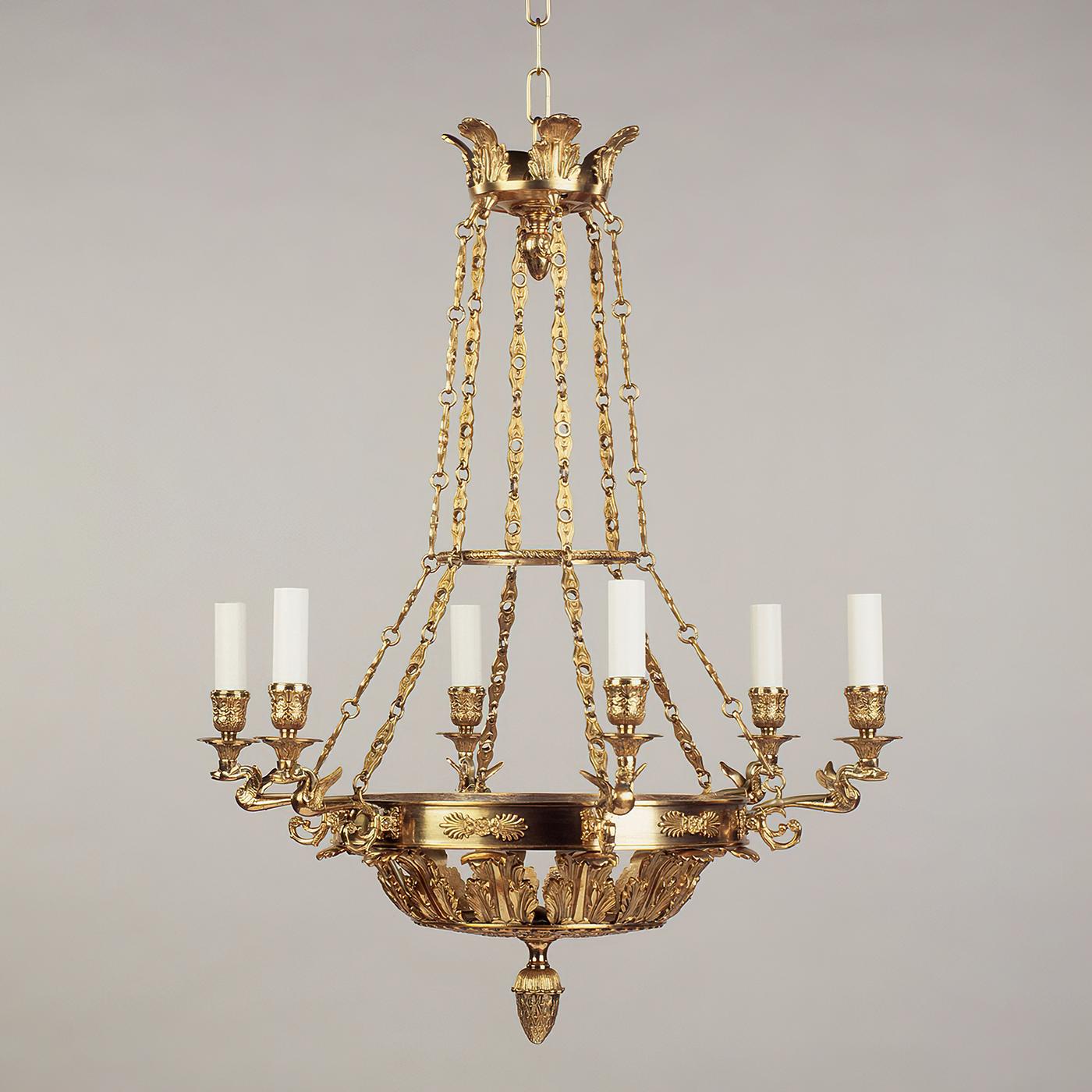 Fontainebleau Empire chandelier, based on a 19th-century French design, the arrangement of the chains and the elaborate cast brass details make this design distinctive. A gilt finish, with acanthus leaves, ornate details, swan form arms and palmette