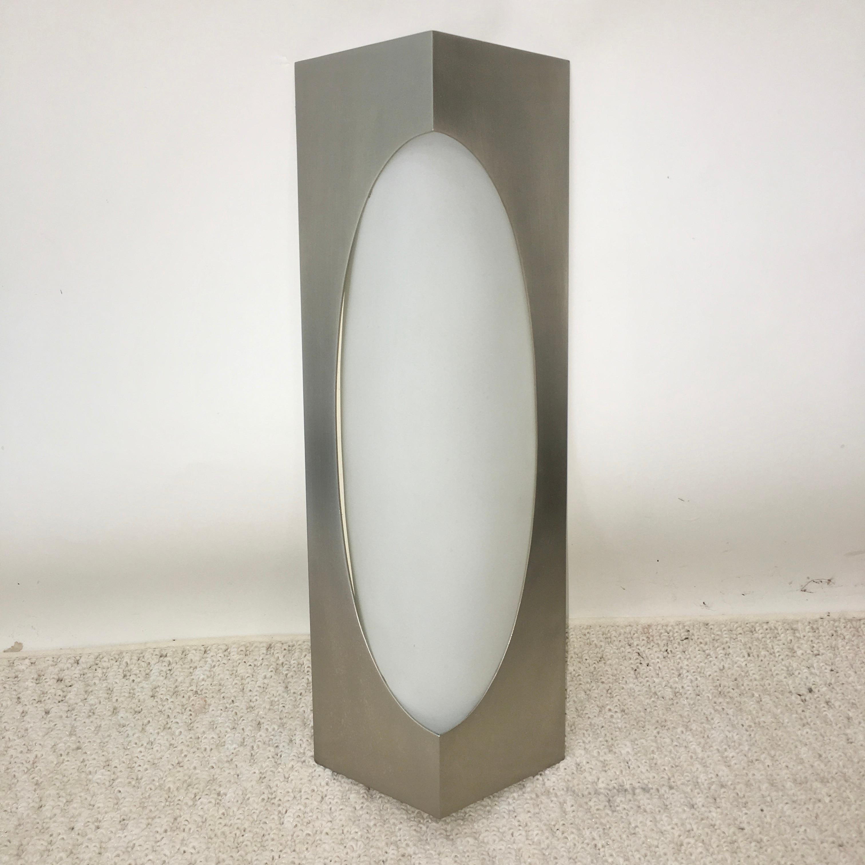 Triangular wedge form wall-mounted lamp by Fontana Arte, circa 1965. Brushed stainless steel frame and opaline glass reflector. Original hefty stainless steel knurled fasteners. See original ad from 1965 Domus magazine. Ideal for a vanity or powder