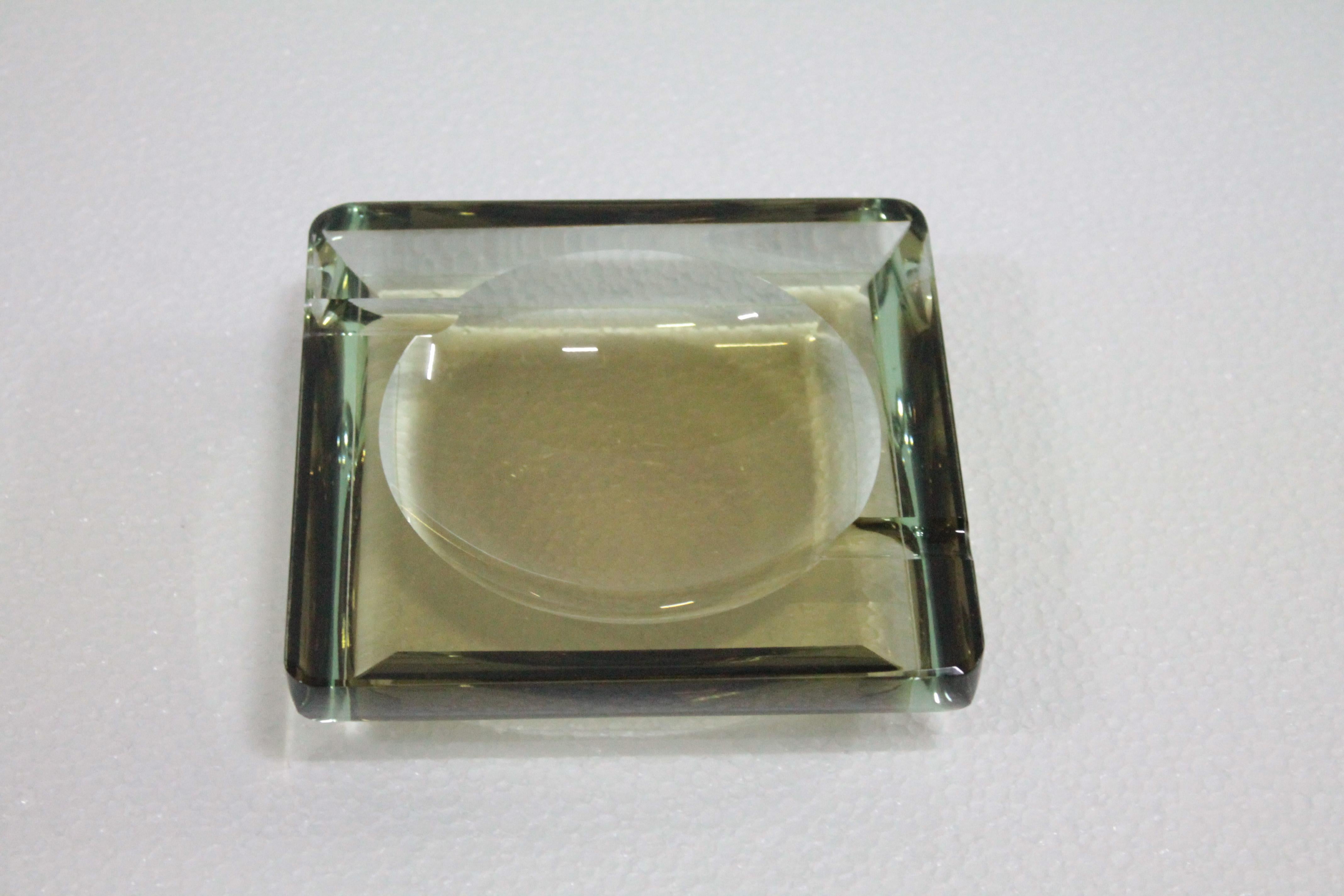 Delicious 1960s thick ashtray produced in Italy by Fontana Arte, perfectly intact, the glass has a double tone that makes it even more unique.

Measurements: W 15 x 15 cm, H 3.5 cm.