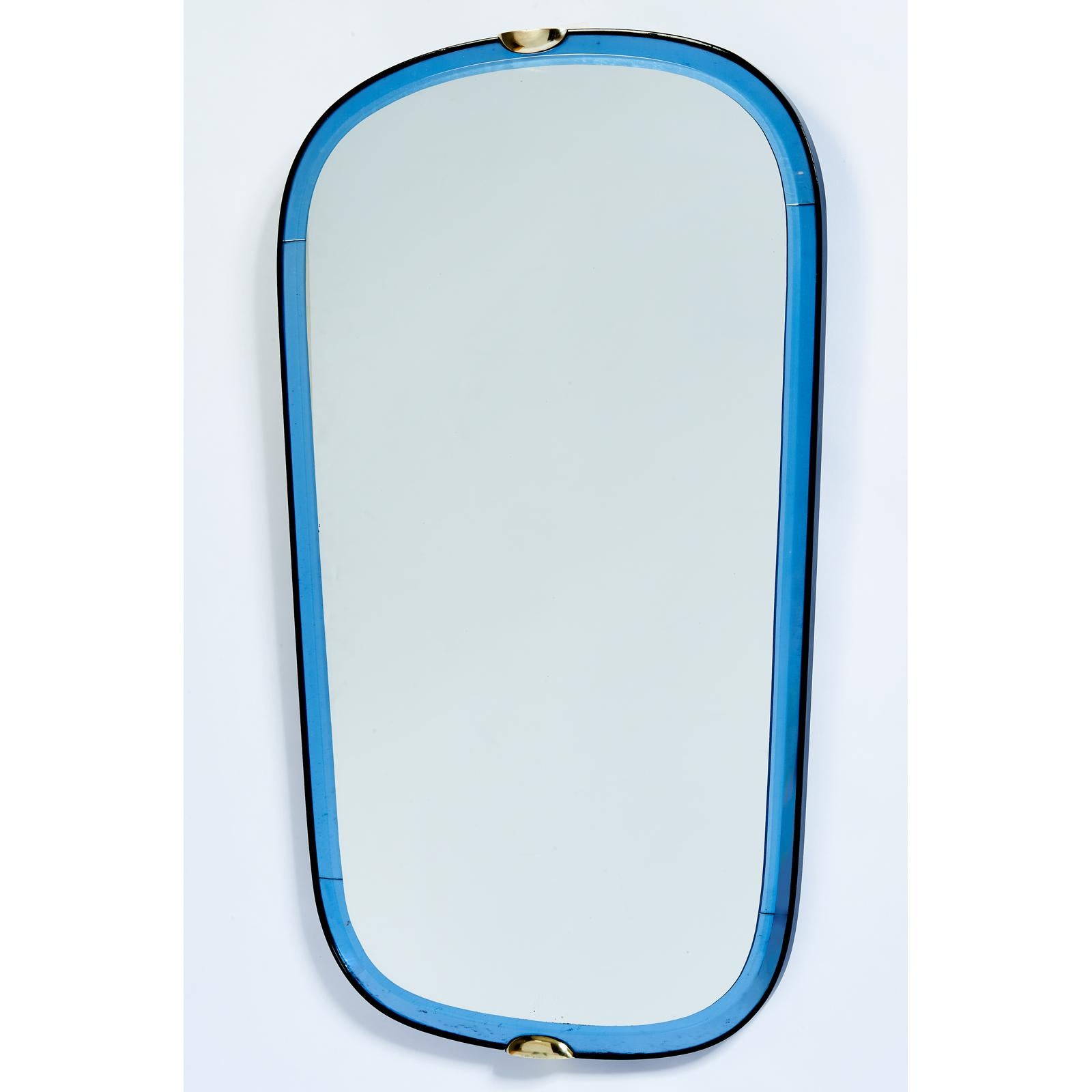 Fontana Arte
A striking beveled mirror by Fontana Arte, bordered with
 blue mirrored glass; black ebonized wood frame; brass mounts.
 Italy 1950s dimensions: 19 W x 32 H
With Galvanit Fontana label in back.