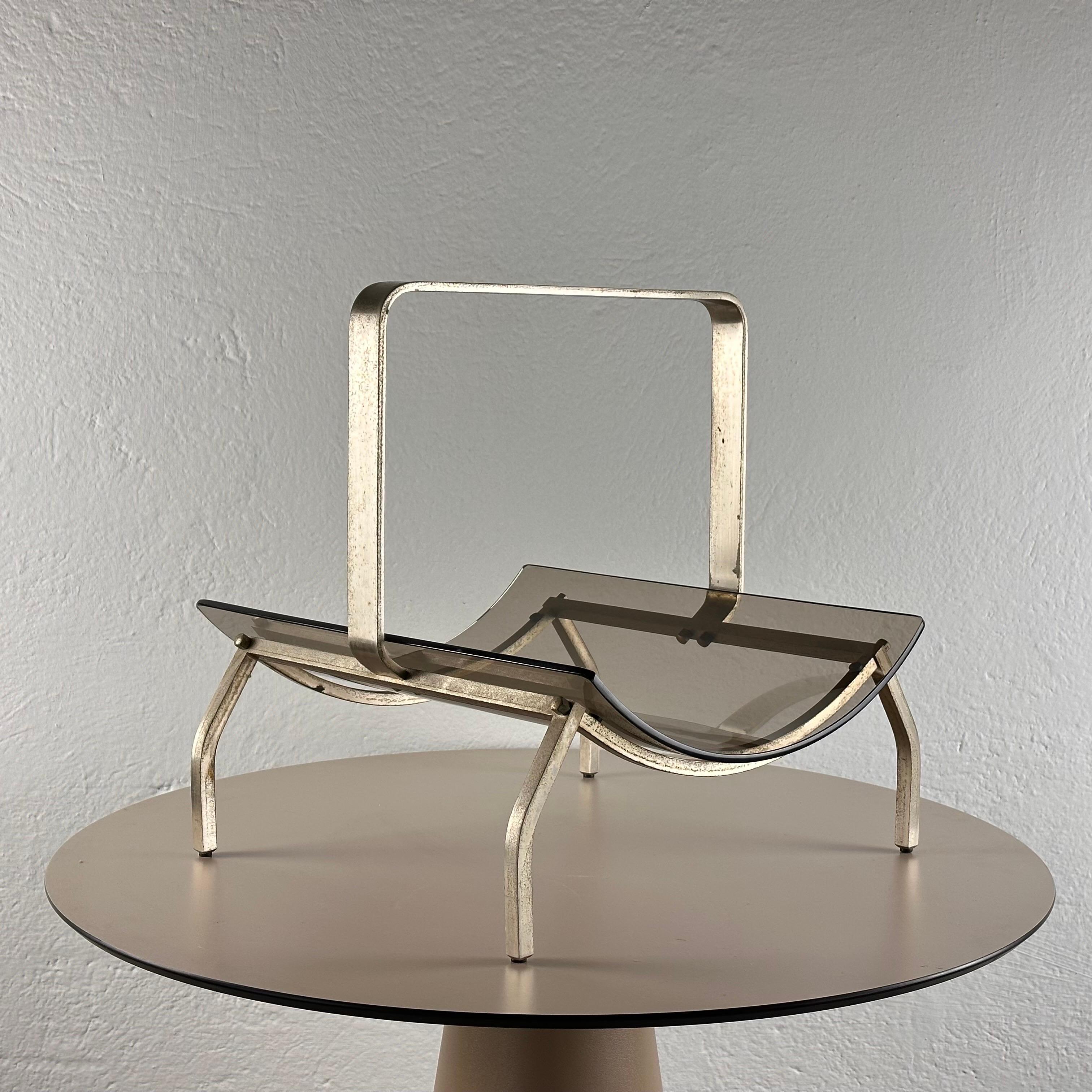 This functional yet artful piece seamlessly blends form and function, embodying the era's sophisticated design ethos.

Crafted with precision, the stand features a curved tempered glass shelf that exudes elegance and modernity. Resting on a sturdy