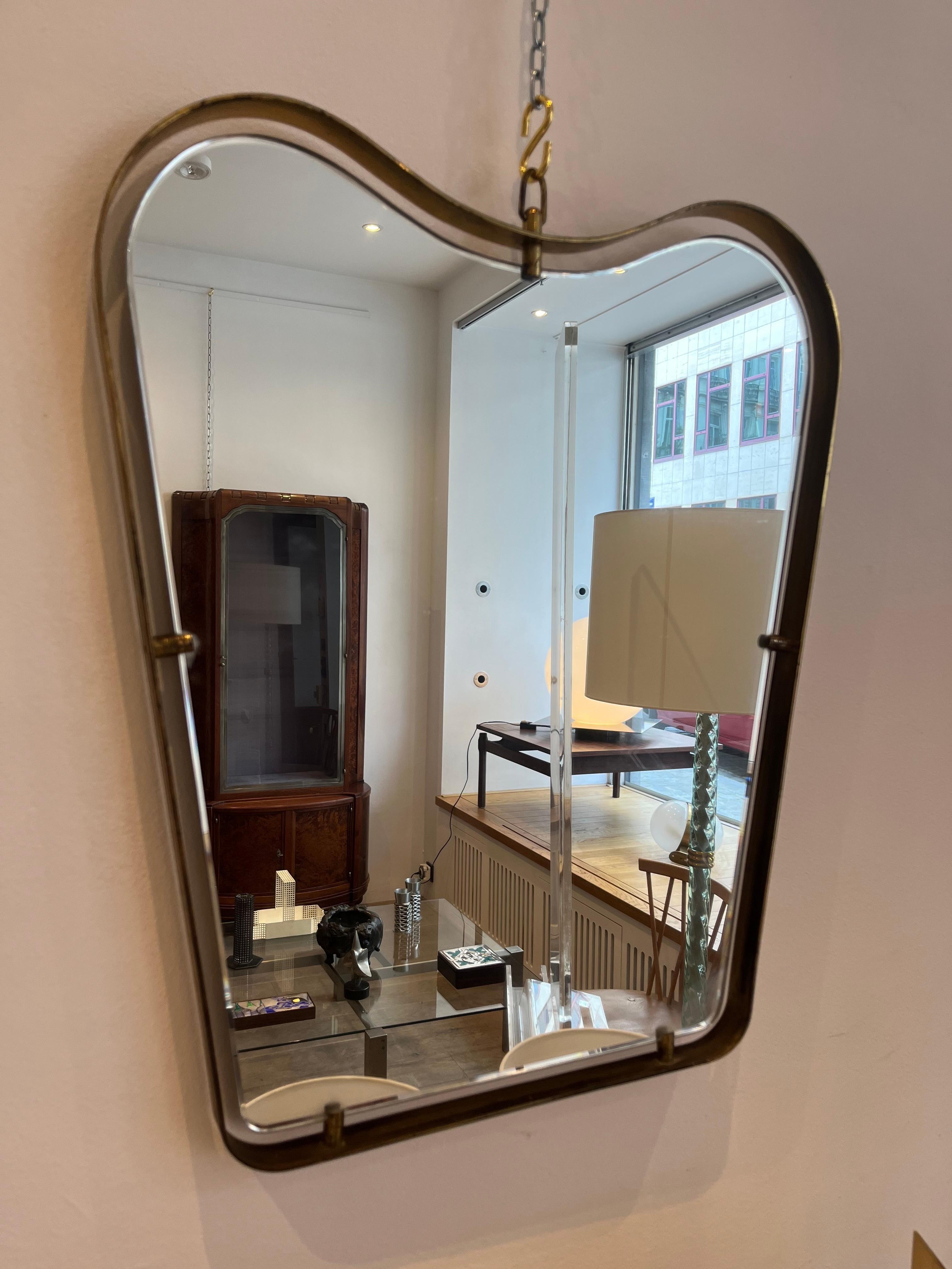 Fontana Arte is an Italian glass making company which created glass furniture. The present mirror is a model of the late forties early 50s. The brass frame is supporting the mirror so as it appears floating in the frame. The design of this type of