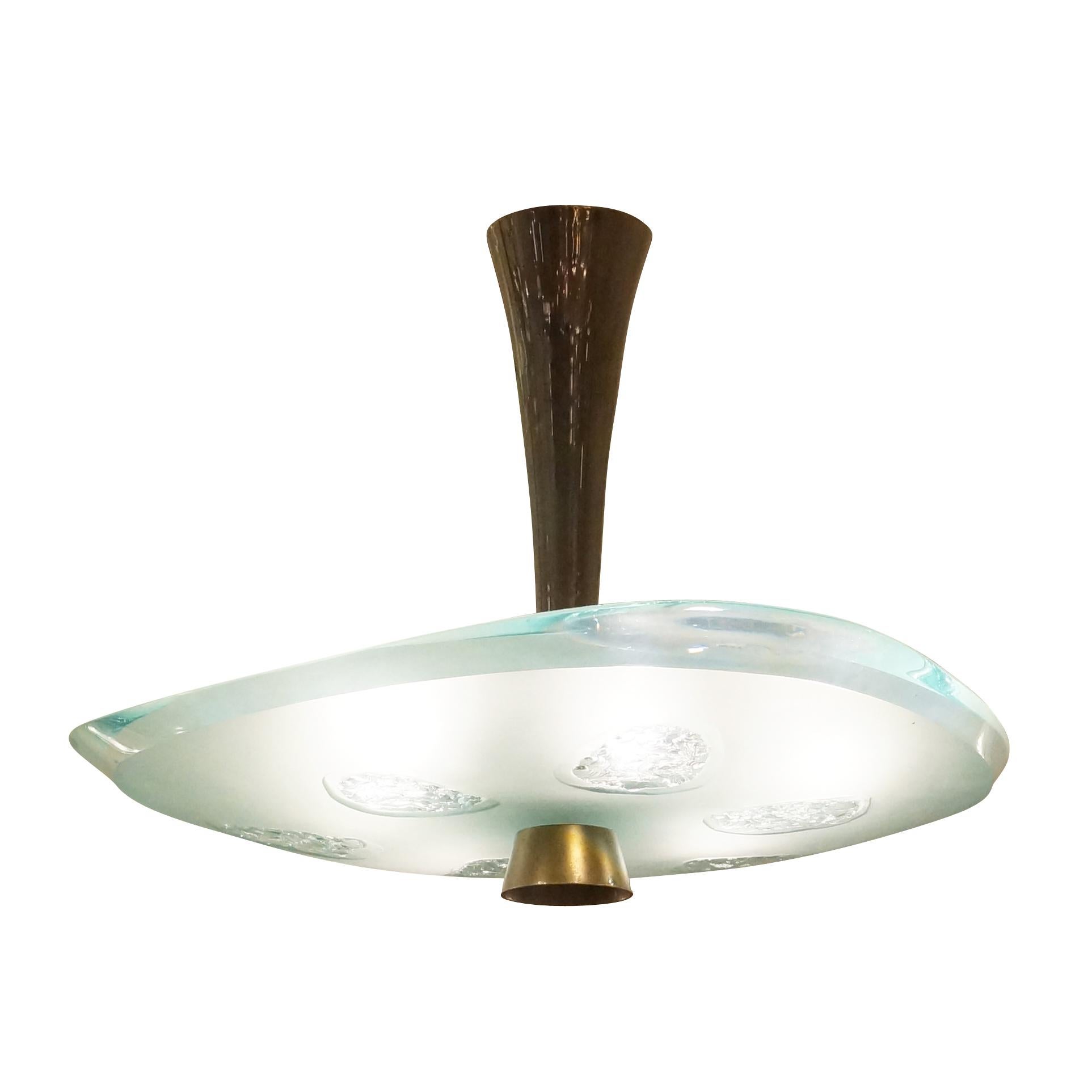 Fontana Arte ceiling light model 1748 designed by Max Ingrand in the 1950s. Features a beautiful thick glass shade with beveled edges which has been chiseled in six irregular areas. Holds six candelabra bulbs. Three available.

Condition: Excellent