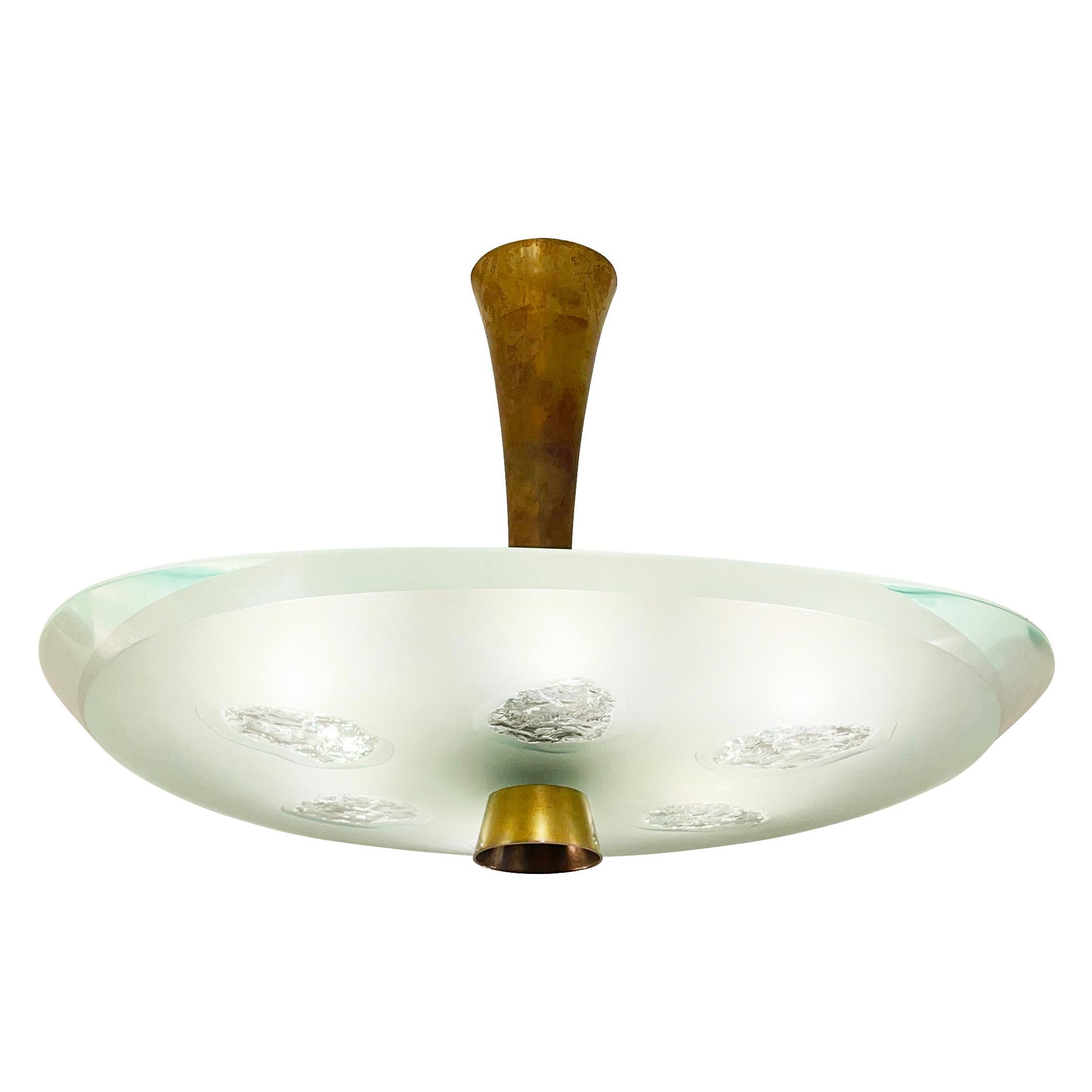 Fontana Arte ceiling light model 1748 designed by Max Ingrand in the 1950s. Features a beautiful thick glass shade with beveled edges which has been chiseled in six irregular areas. Holds six candelabra bulbs.

Condition: Excellent vintage