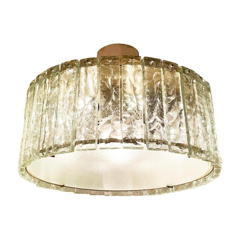 Fontana Arte ceiling light model 2448 designed by Max Ingrand in the 1960s. Features a nickel-plated structure holding dozens of chiseled glasses. Closed at the bottom by a frosted glass diffuser. Holds eight candelabra sockets and one Edison