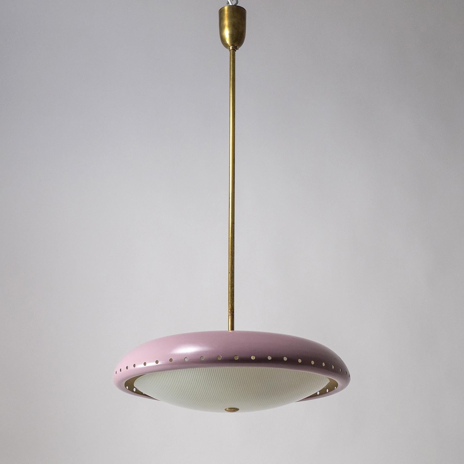 Rare modernist 'UFO' chandelier by Fontana Arte from the 1950s. Brass hardware with a large lavender lacquered perforated shade and a geometrically textured glass diffuser. Very nice condition with some light wear to the paint and a nicely aged