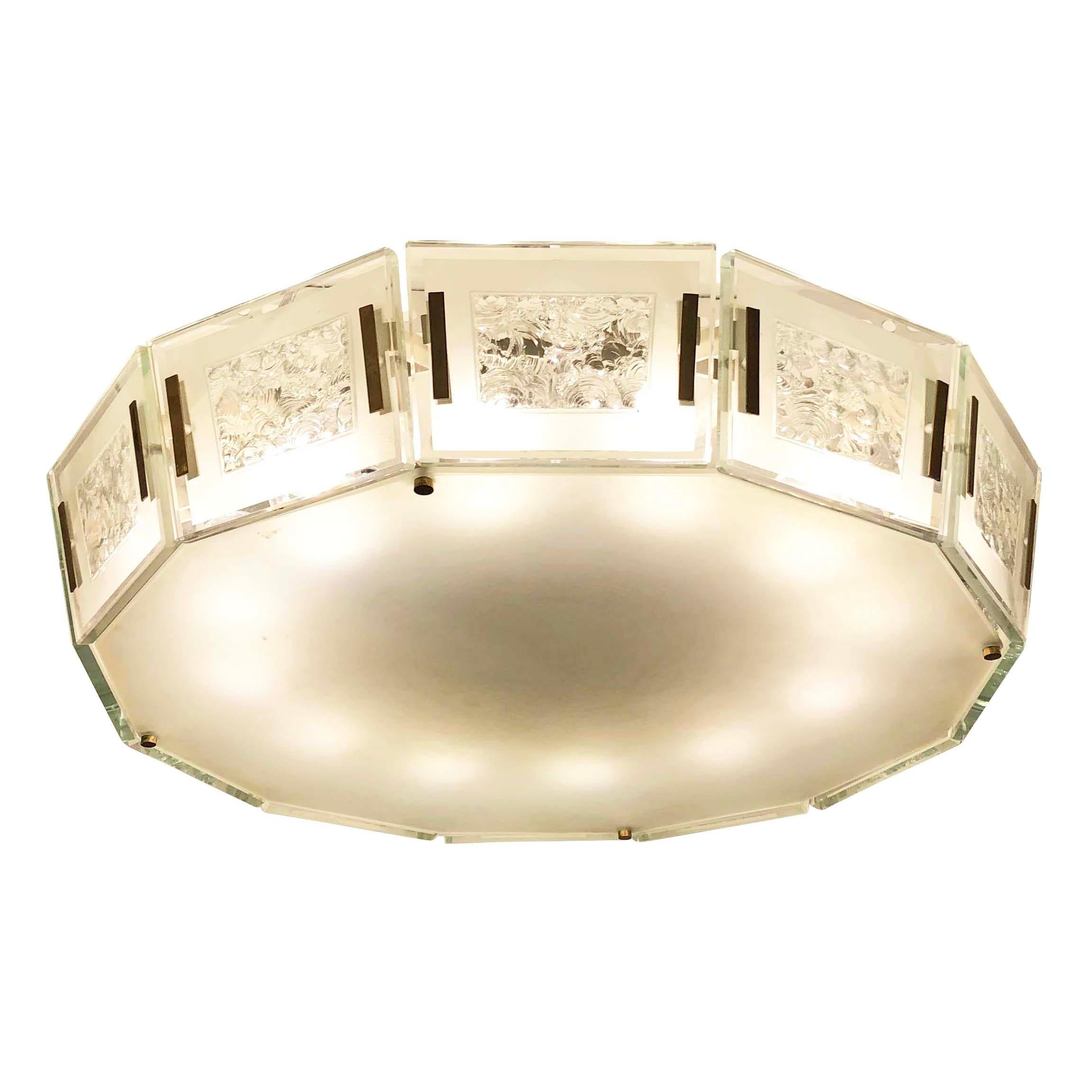 Fontana Arte ceiling light model 2270 designed by Max Ingrand in the 1960s. Composed of a flat twelve sided glass framed by glass panels with chiseled centres and brass fittings. All the glass is light blue/green as typical of Fontana Arte pieces.