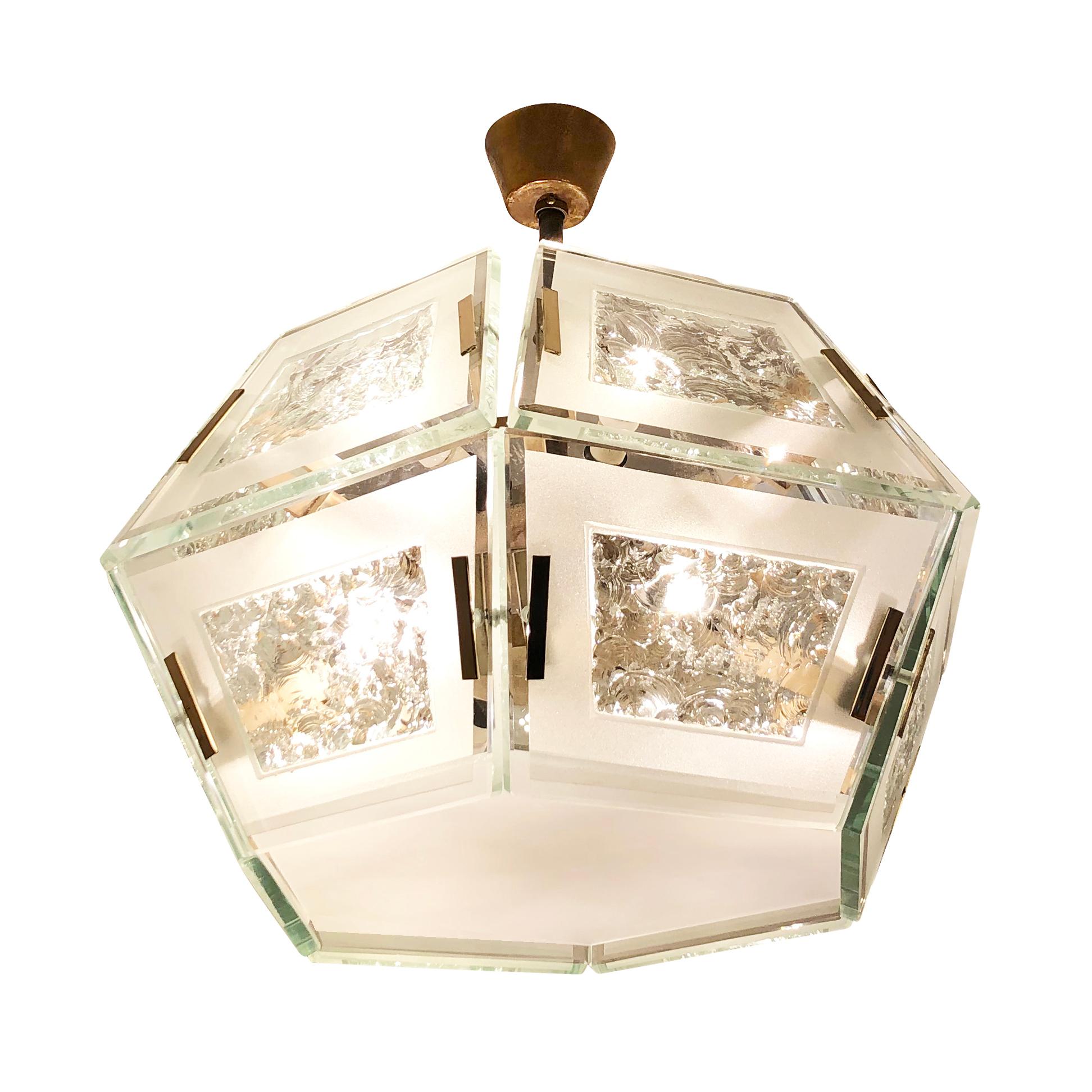 Rare Fontana Arte chandelier model 2362 designed by Max Ingrand in the 1960s. Its hexagonal form is composed of twelve frosted glass tiles with hand chiseled centers. Brass details and fasteners and holds twelve candelabra bulbs.

Condition:
