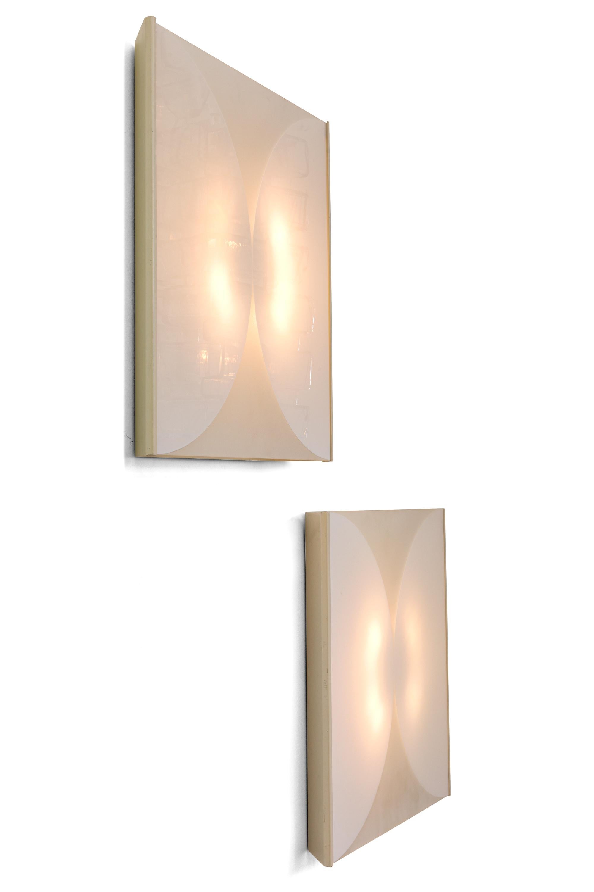 These lights are made with glass panels that have been sandblasted to create the design and are housed in a shallow white metal frame. Available as a pair or singly.