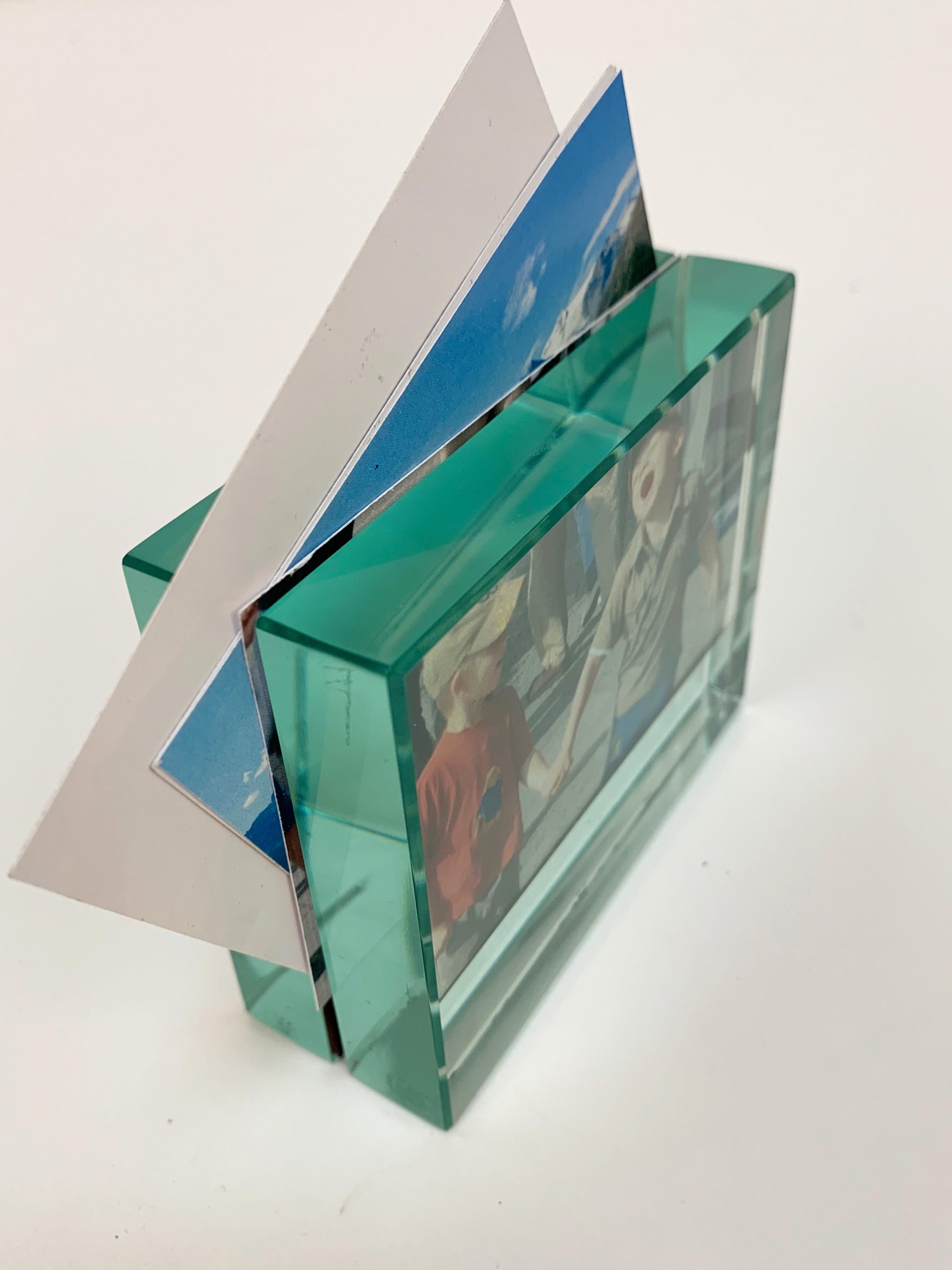 Fontana Arte Minimalist frame. Heavy beveled green glass with opening slot for one or two photos in the middle.
At the base the glass is mirrored,
circa 1980s.