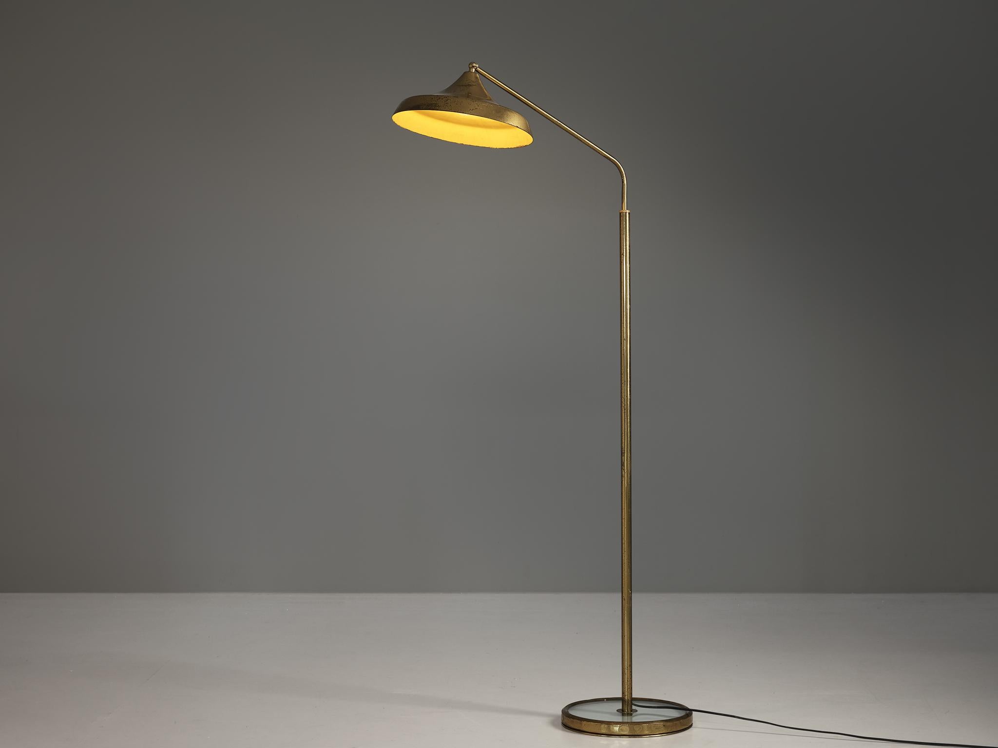 Fontana Arte, floor lamp, model, '2418', brass, glass, Italy, 1960s.  

The Fontana Arte model 2418 floor lamp, produced in the 1960s, is deceptively simple, yet distinctly architectural. The stem rises cleanly from a circular glass base, which,