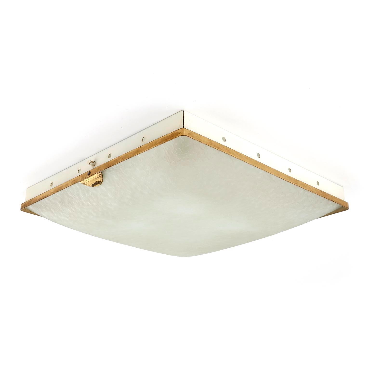 A square flushmount light or wall light fixture by Fontana Arte, Italy, manufactured in midcentury circa 1950.
The lamp is made of a white painted backplate, polished brass with lovely patina, and a slightly domed satined glass lamp shade with an