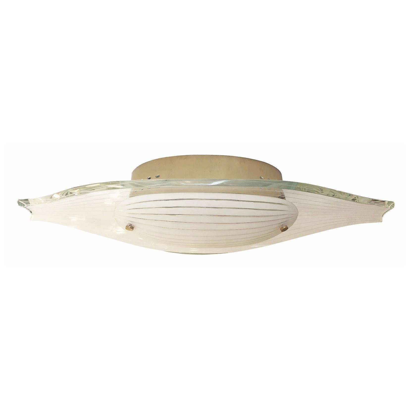 Fontana Arte flush mount model 2340 deigned by Max Ingrand in the 1960’s. Composed of a contoured hand polished glass with a frosted glass diffuser at the center. Both glasses have thin etched lines the follow the sloping shape of the fixture.