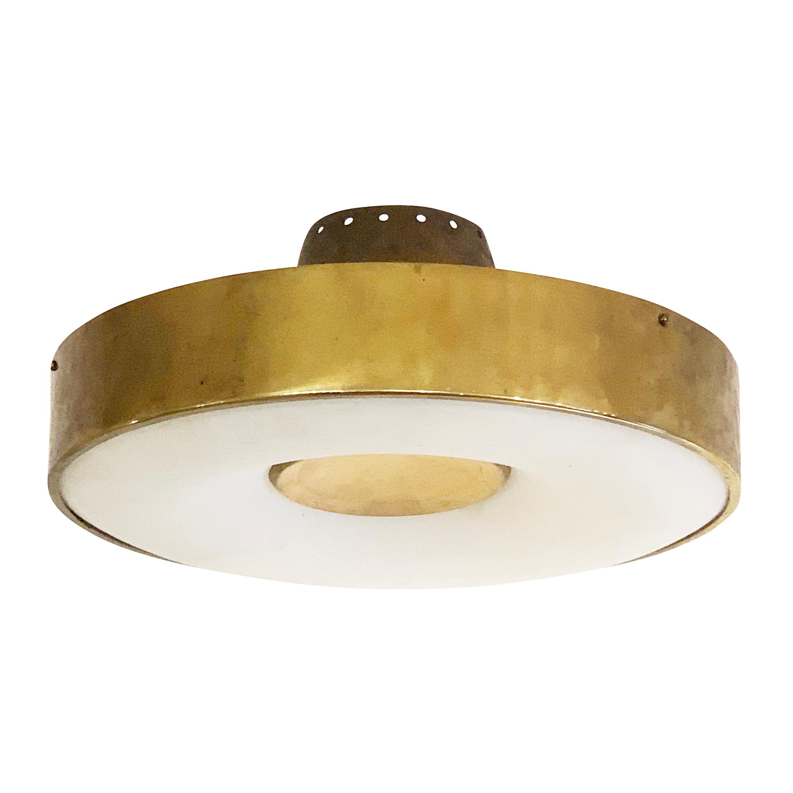 Fontana Arte ceiling light model 2134 designed by Max Ingrand in the 1960s. Features a polished brass band around a frosted glass diffuser. The center is lacquered off-white. Holds four candelabra sockets.

Condition: Good vintage condition, minor