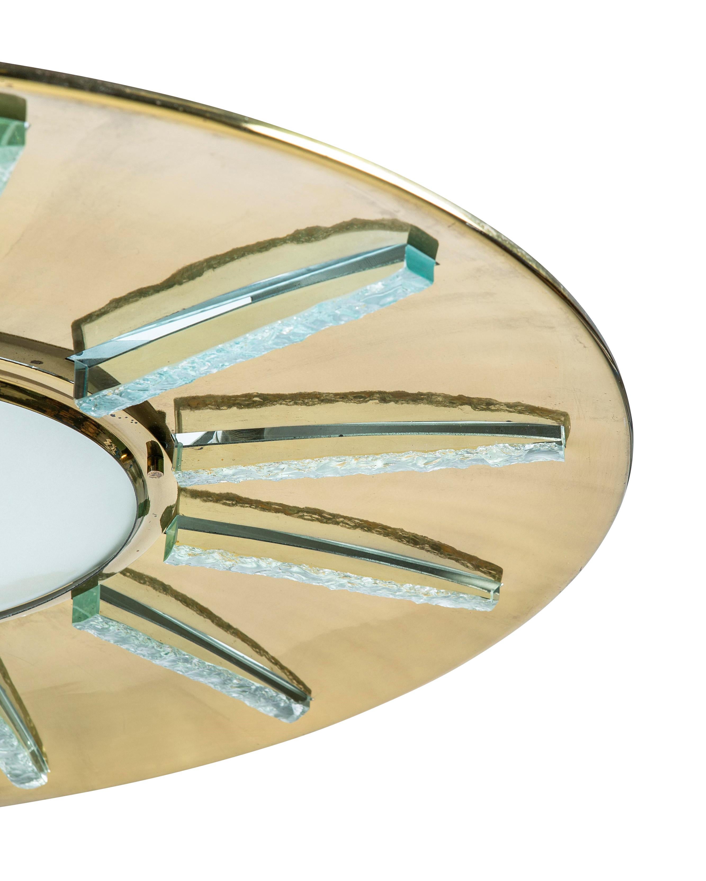 Rare Fontana Arte ceiling light model 2271 designed by Max Ingrand in the 1960s. Features a polished brass frame with a radial glass design. The central white frosted glass is convex while the other glass elements are greenish in appearance due to