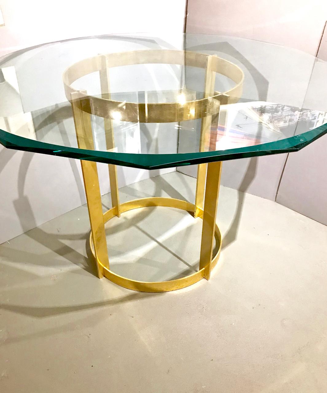 This is a stunning gilt bronze and glass center or dining table attributed to/style of Fontana Arte that dates to circa 1980s. This super chic table is the perfect all occasion table: it will seat 4-5 persons comfortably or it can act as a