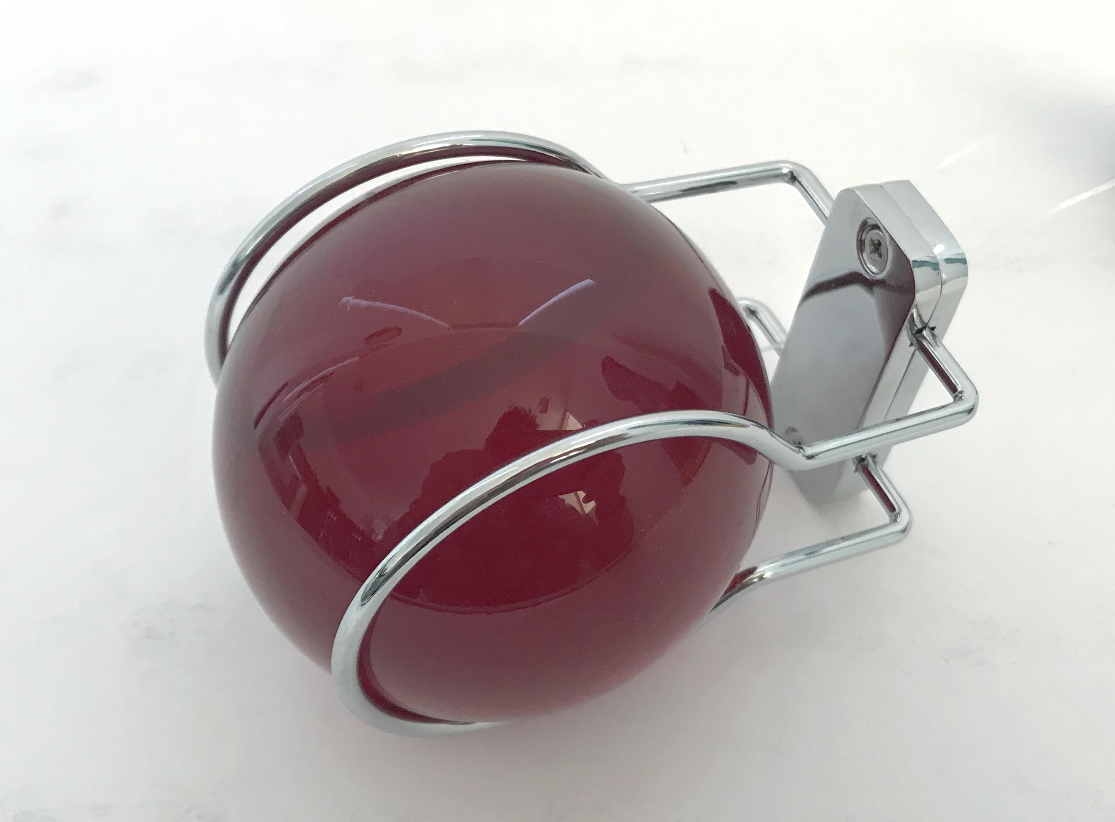 Italian coat or hat hanger with a single red glass ball mounted on chrome bracket / Made in Italy by Fontana Arte, circa 2000s
New and unused, with original tag and package
Measures: Height 2.75 inches, width 2.75 inches , depth 3.5 inches
1 in
