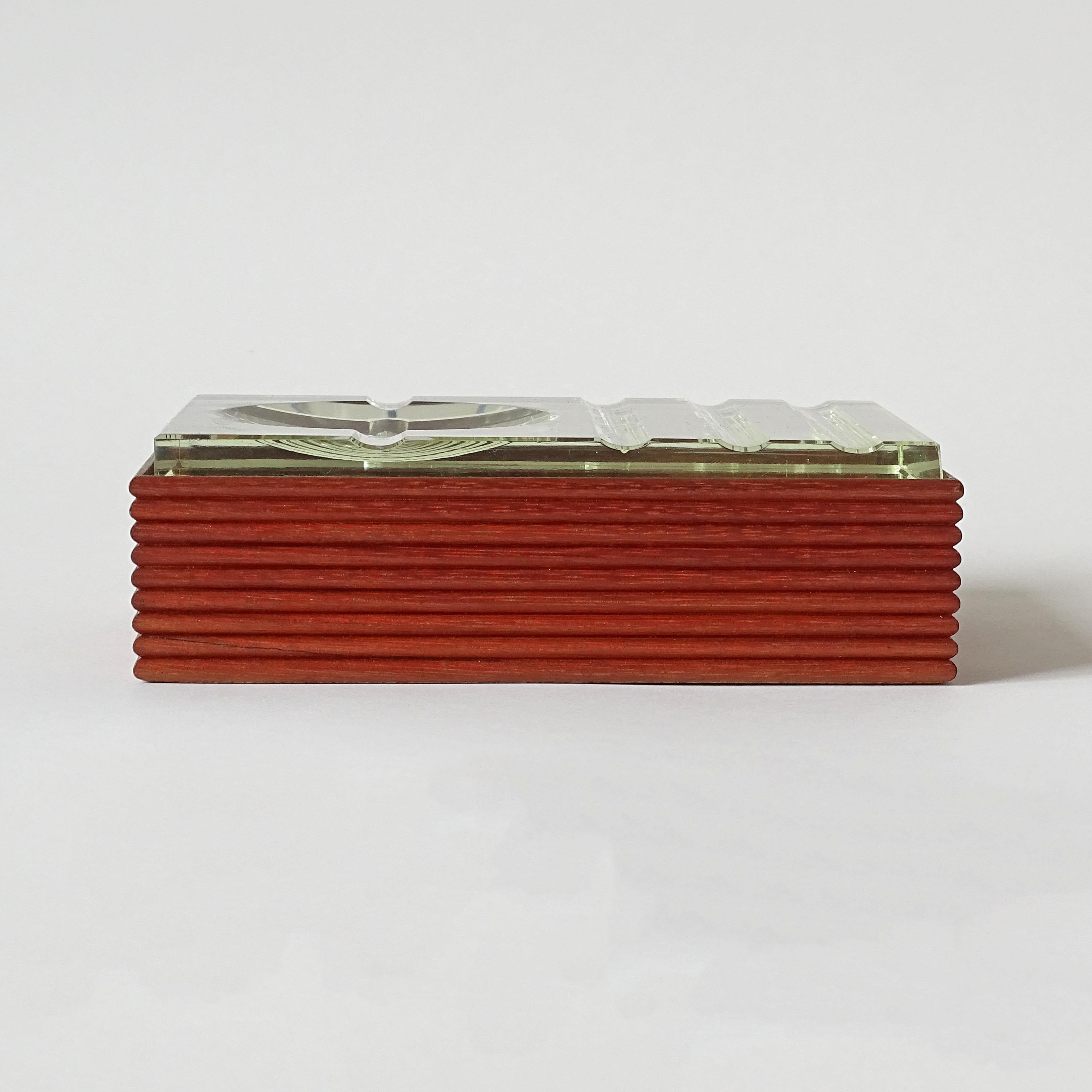 Fontana Arte ashtray-shaped cut glass cover and sculpted wood box, Italy, 1950s.