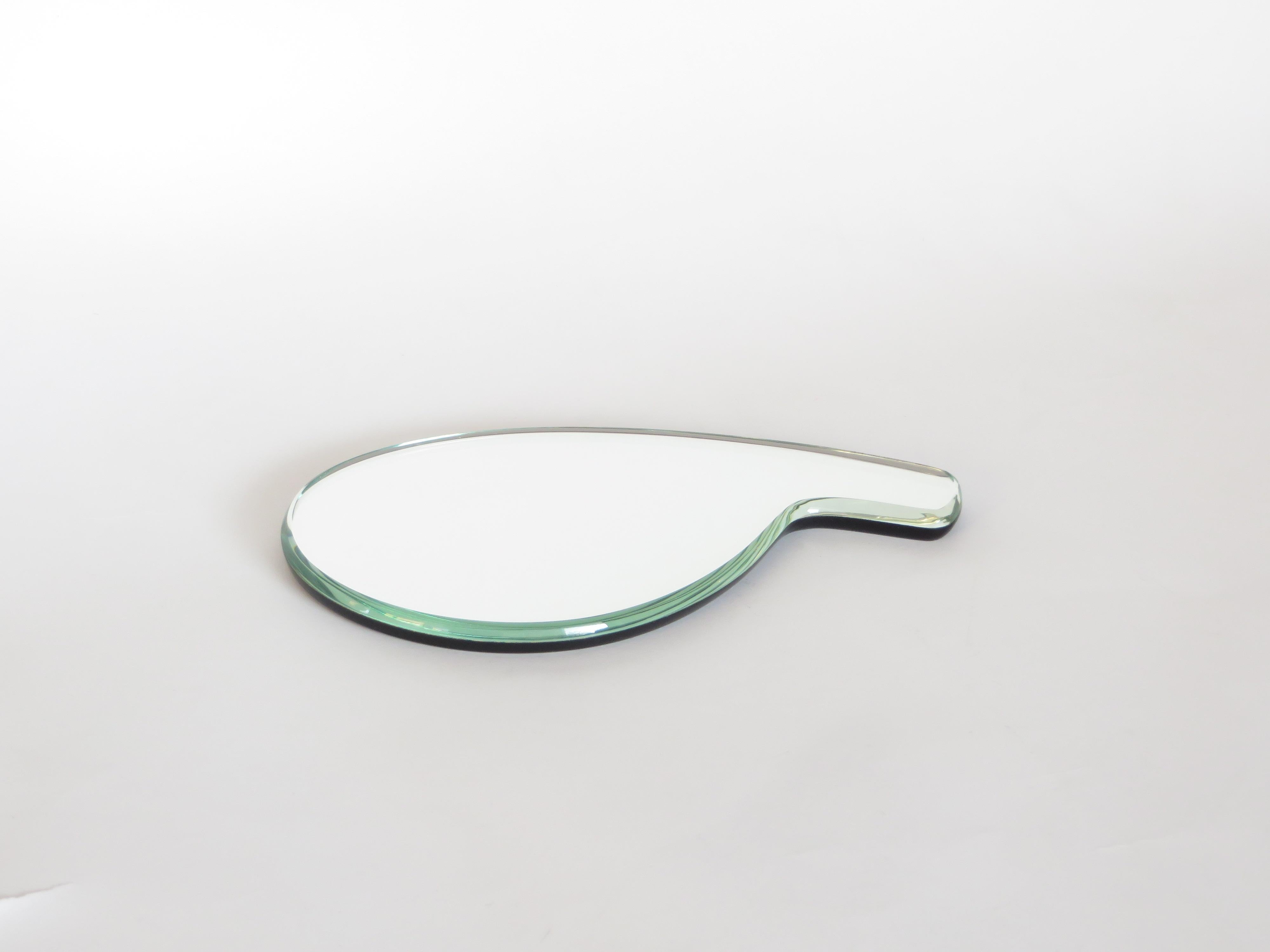 A hand mirror designed by Gio Ponti for Fontana Arte with beveled glass edges and black glass backing.
Designed in 1932, this example most likely produced in the 1990s. Perfect condition, no chips, no scratches.
Literature: Laura Falconi, Fontana