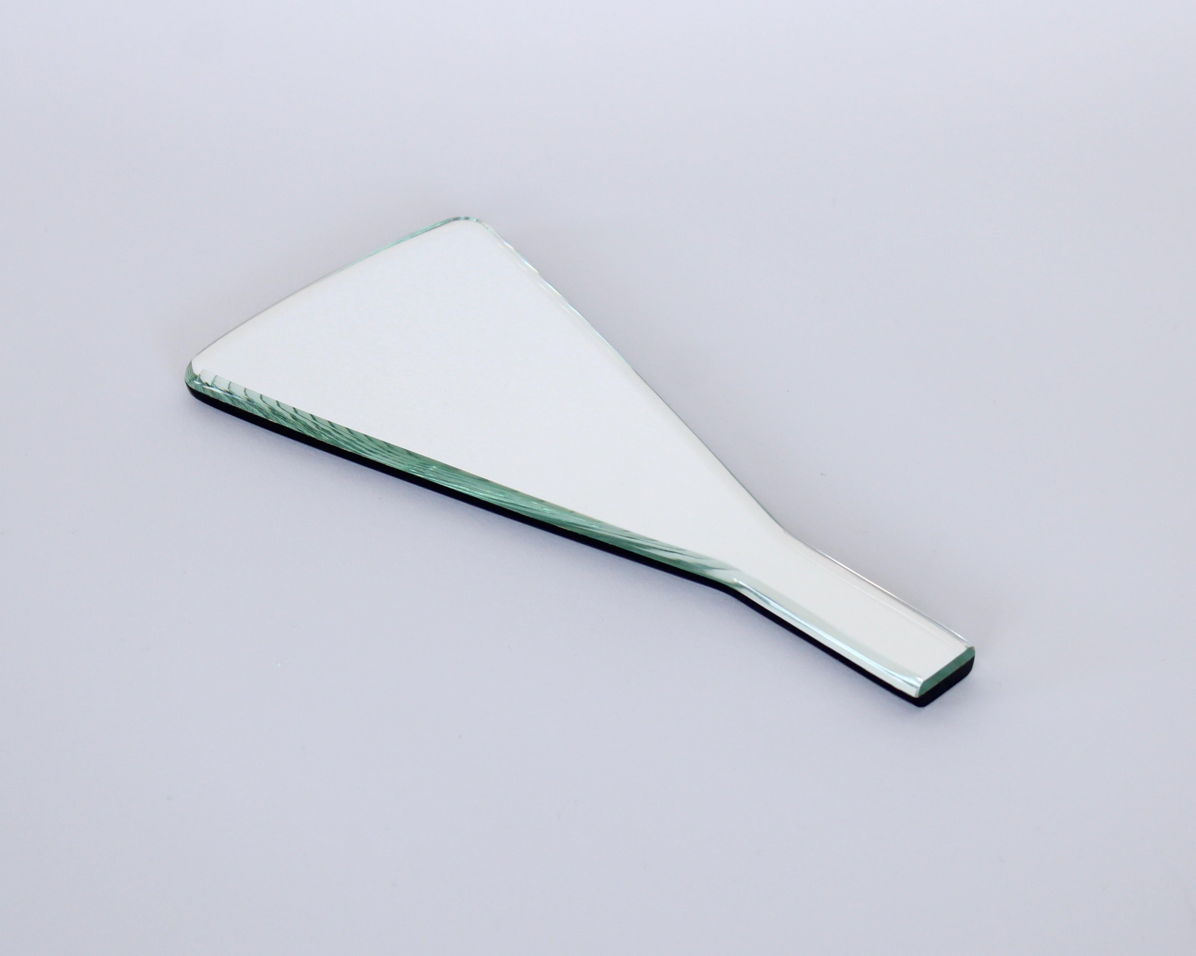 A hand mirror, model number 2032, designed by Gio Ponti for Fontana Arte with beveled glass edges and black glass backing. Comes with original box and certificate of authenticity.
Model number 2032, 31 of 899. 
Designed in 1932, this example most