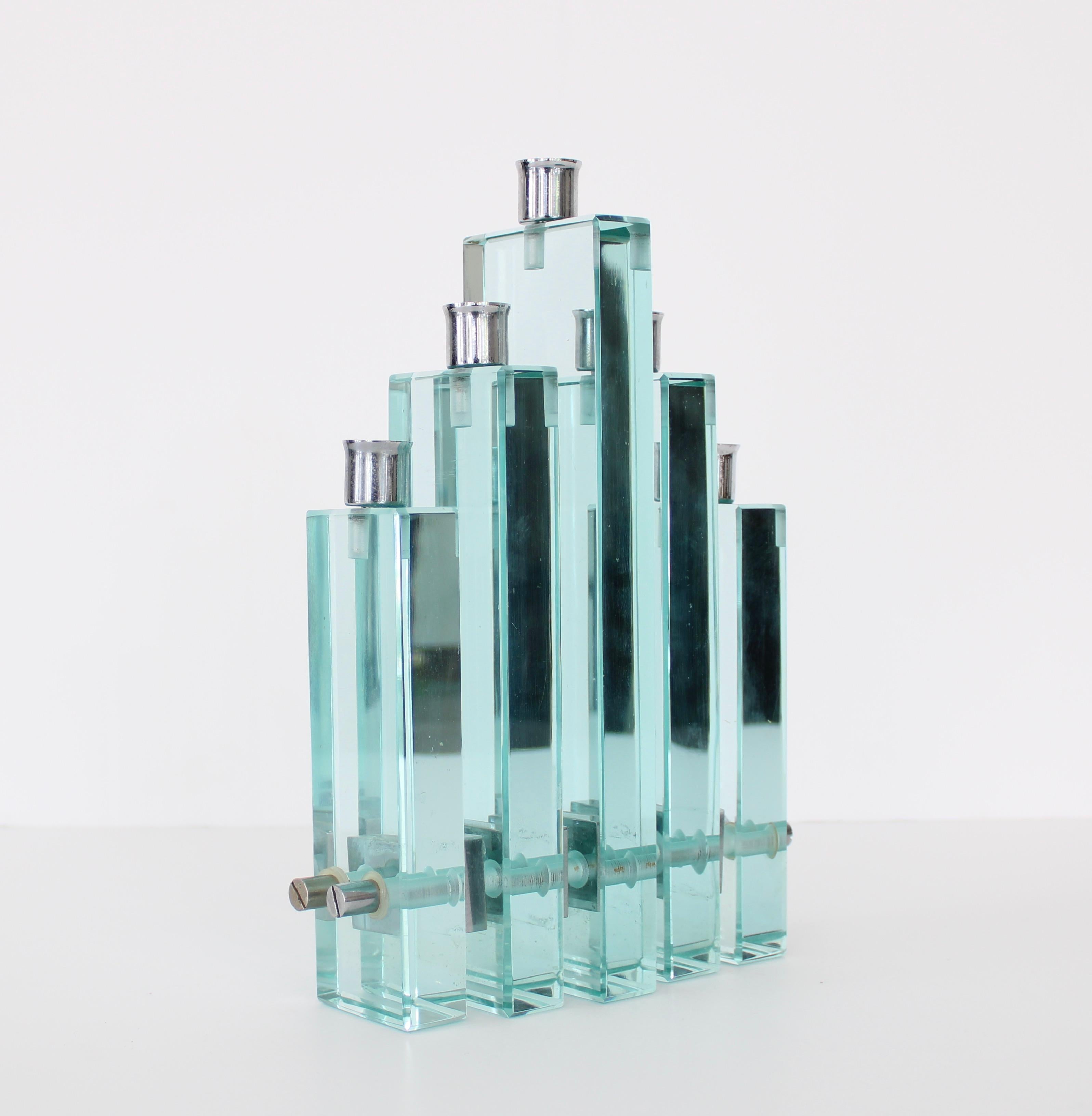 Fontana Arte designed by Pietro Chiesa iconic green glass Italian 5 part glass candleholder with chrome candleholders and chrome details on sides.
Composed of chrome rods keeping the individual candleholders together terminating in chrome screws.