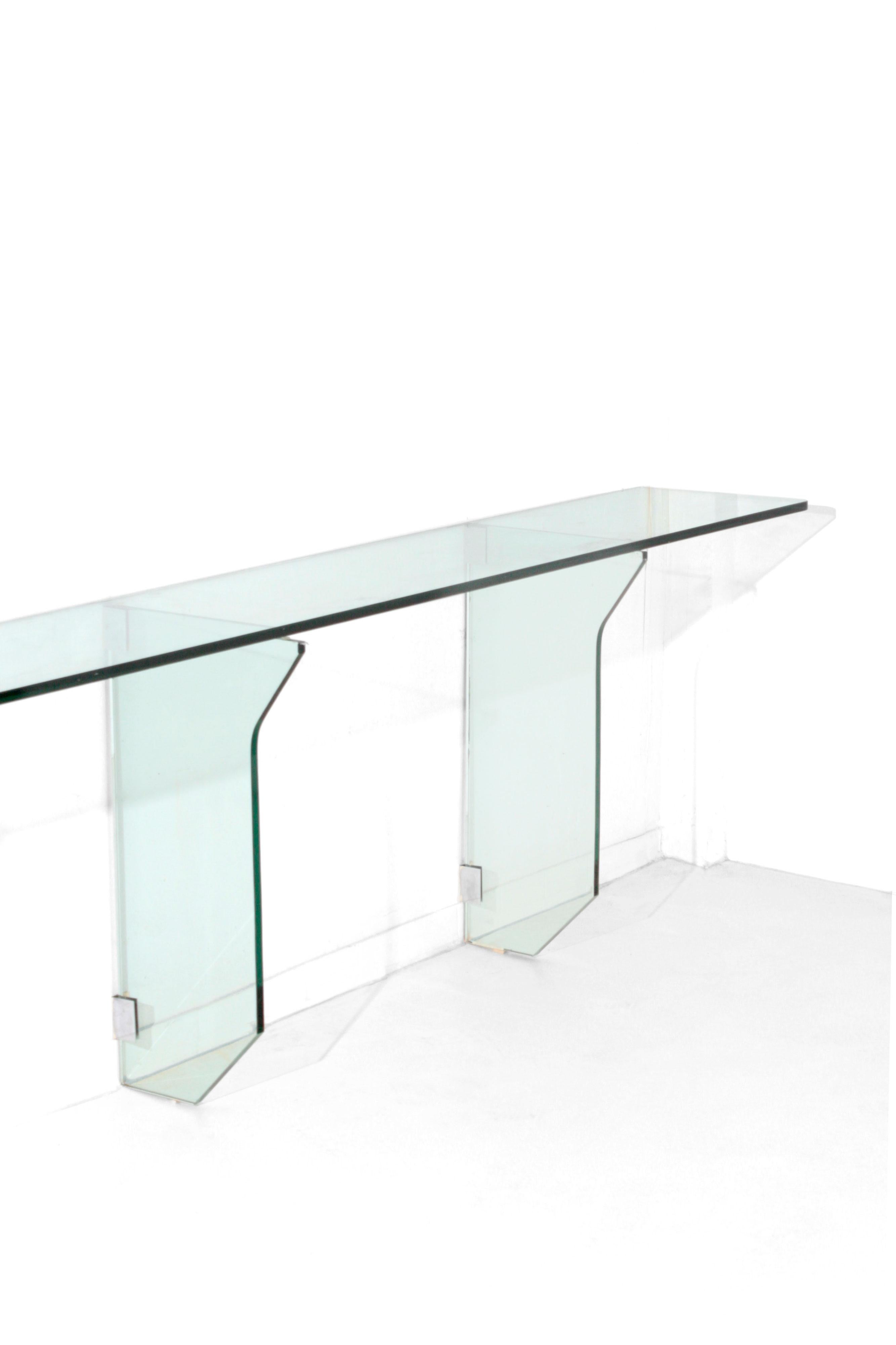 Fontana Arte. Large console in thick glass with three supports in ground and shaped glass. As you can see from the photo the console is supported by three shaped glass pedestals. Supports and details in nickel-plated brass.
Given its size, the