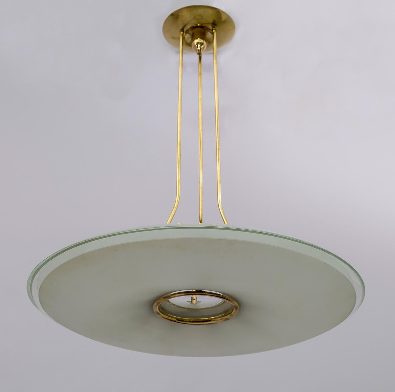 Chandelier attributed to Max Igrand for Fontana Arte, Italy, circa 1950s. Cast brass and curved crystal. Two large curved etched glass lampshades mounted on a brass frame, at first glance it is in excellent condition, has small chips and two cracks