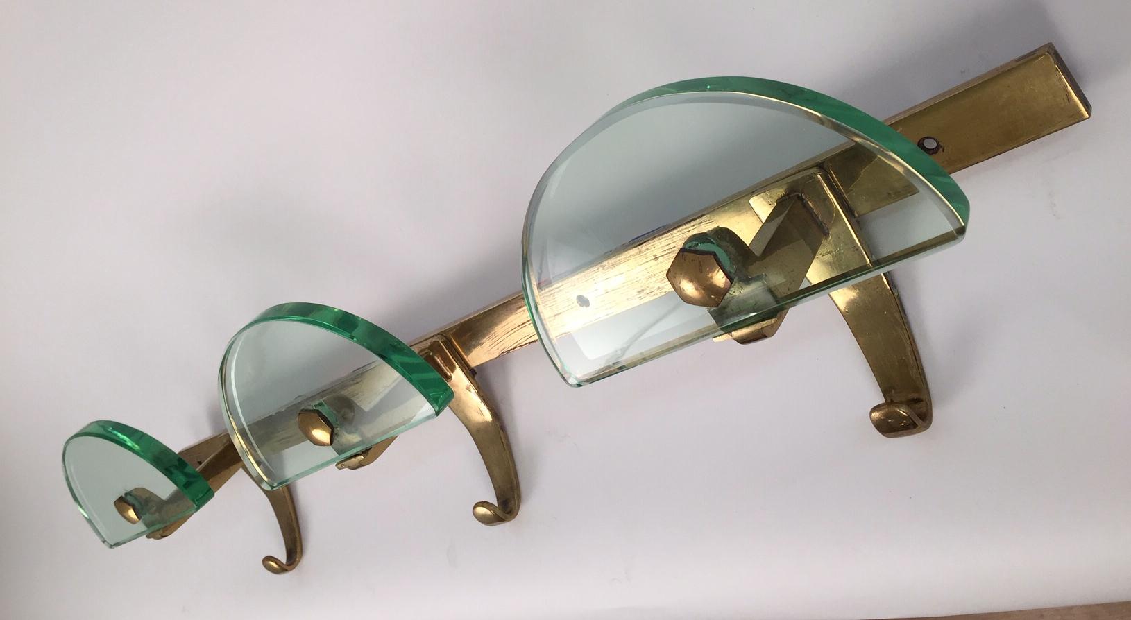 A very rare Fontana Arte three hanger mounted coat rack. Brass and thick cut-glass. Excellent condition.