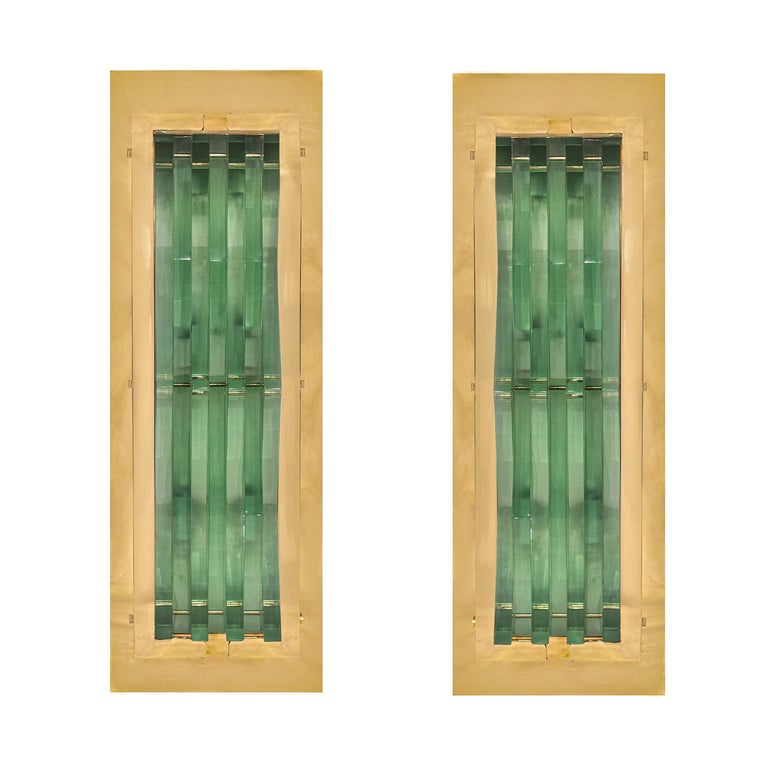 Pair of stunning large wall sconces in polished brass with handcut angular glass inserts by Max Ingrand for Fontana Arte, Italy 1950s. These sconces have been polished, lacquered and newly rewired. 

Reference:
Fontana Arte: Gio Ponti, Pietro