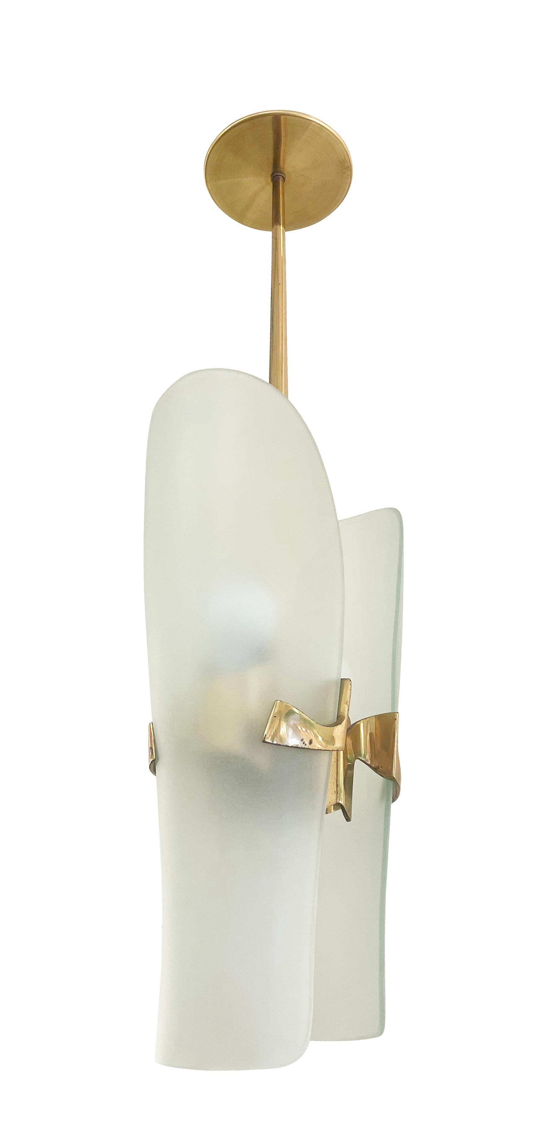 Fontana Arte Pendants, designed by Max Ingrand in the 1960s. Each frosted glass shade mounts on a cast brass bracket and covers an E26 bulb. 

Three available- price listed per pendant.

Condition: Excellent vintage condition, minor wear