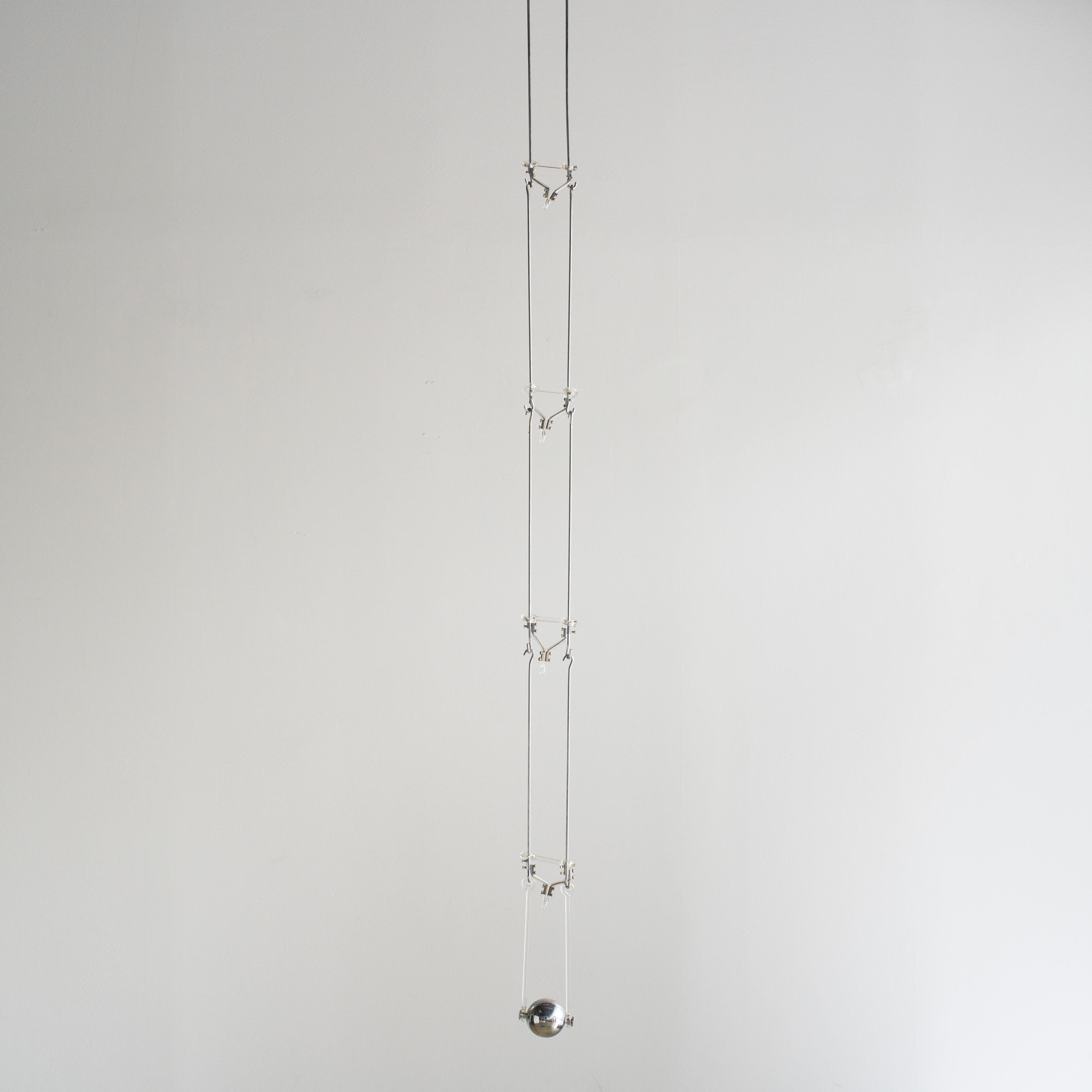 Sculptural hanging light designed by Livio Castiglioni in 1972. Produced by Fontana Arte.  
This lighting fixture consists of one base and six hanging units and one weight. Hanging unit are added to hook.  Therefore total length will be change. 