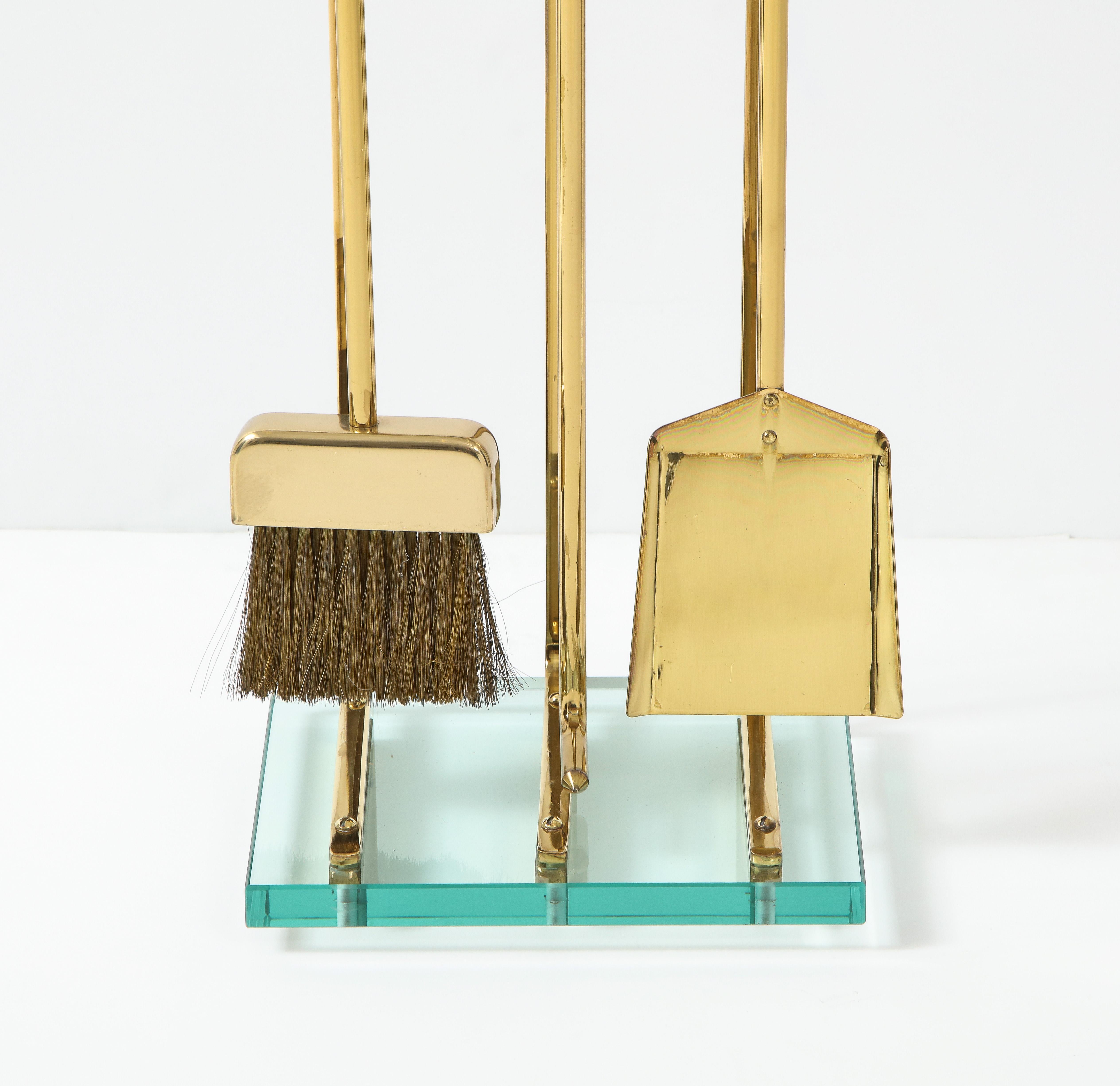 Stunning set of 1970's Mid-Century Modern brass and glass fireplace tools in the style of Fontana Arte, in vintage original condition with minor wear and patina due to age and use.